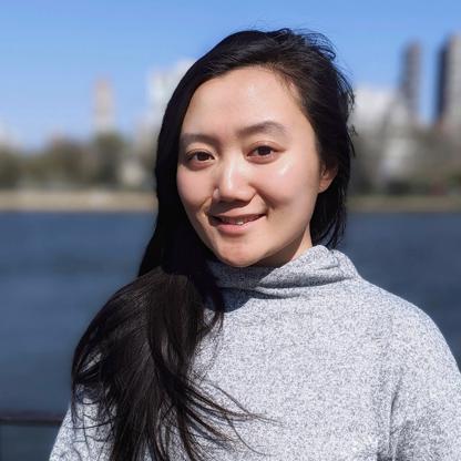 Hara Wang with a background of water and a city skyline