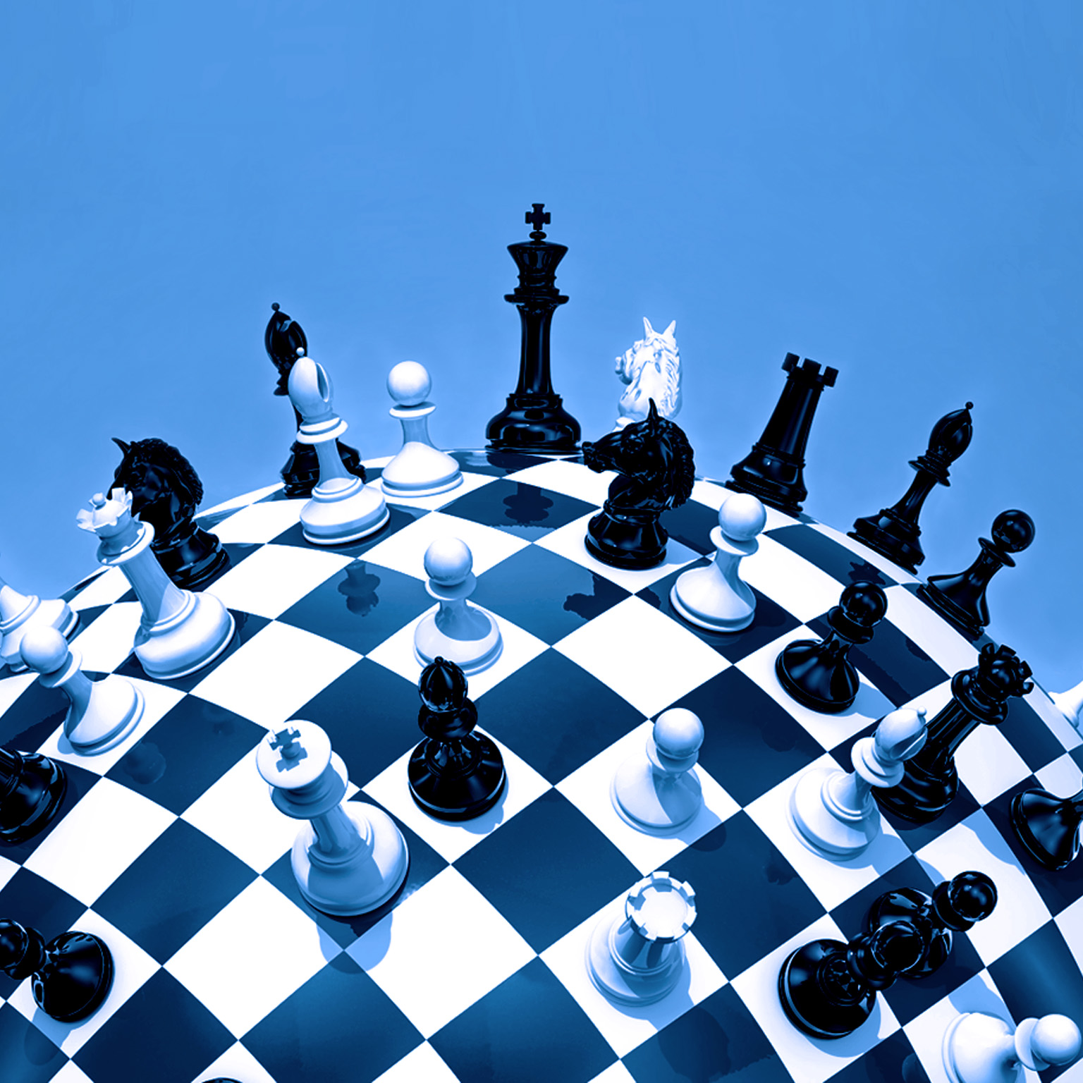 A globe styled as a chessboard, with chess pieces scattered across its surface.