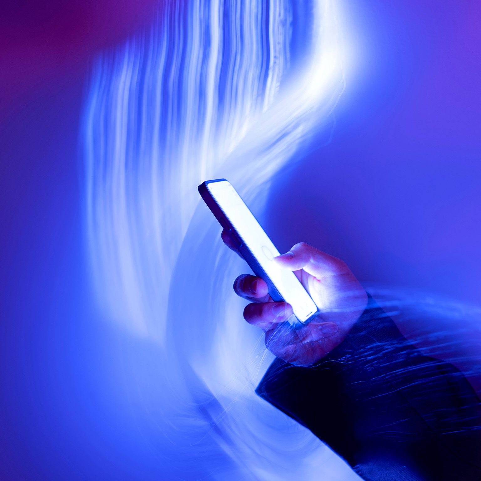 Close-up of using mobile phone on holographic background
