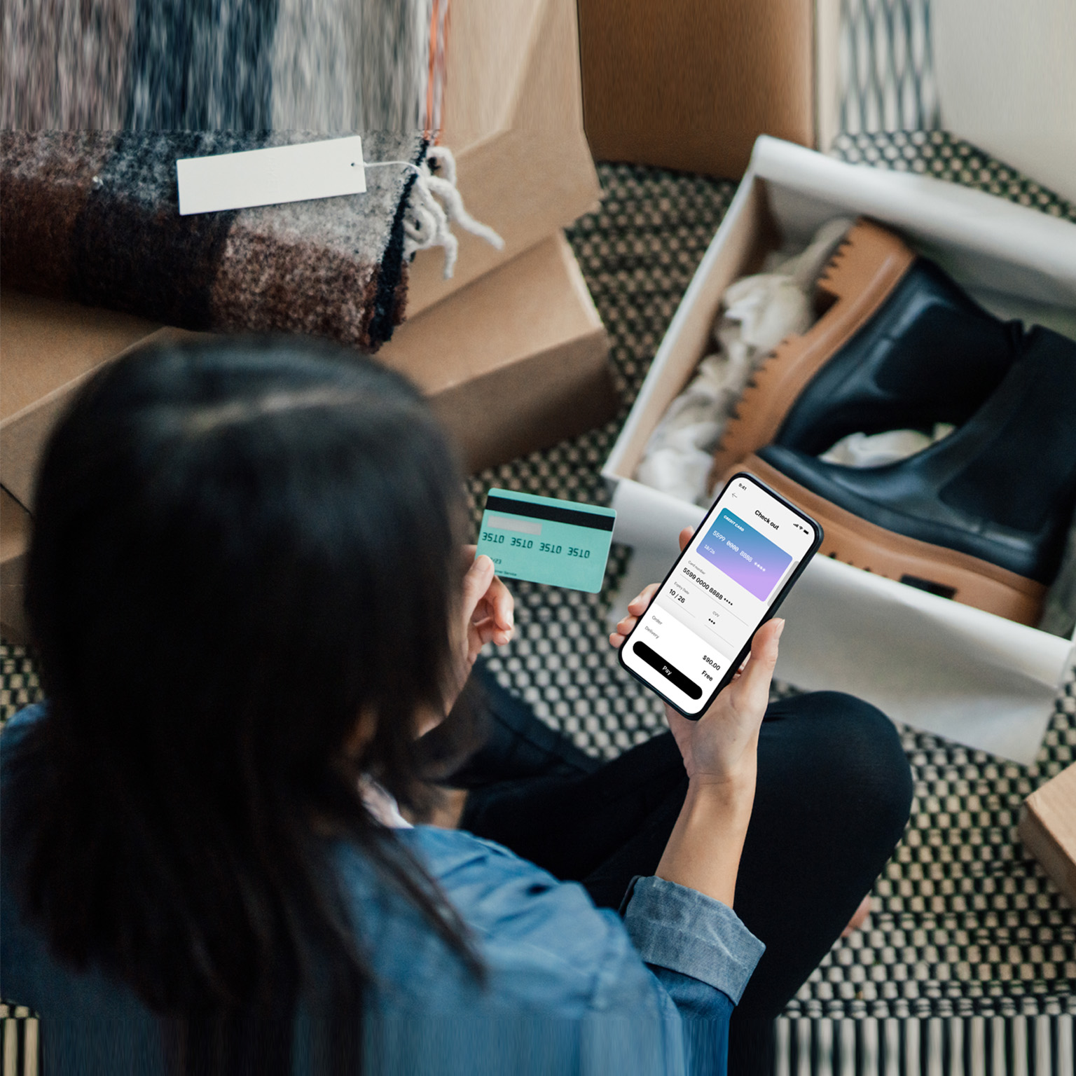 Overhead View Of Young Woman Doing Online Shopping With Smart Phone