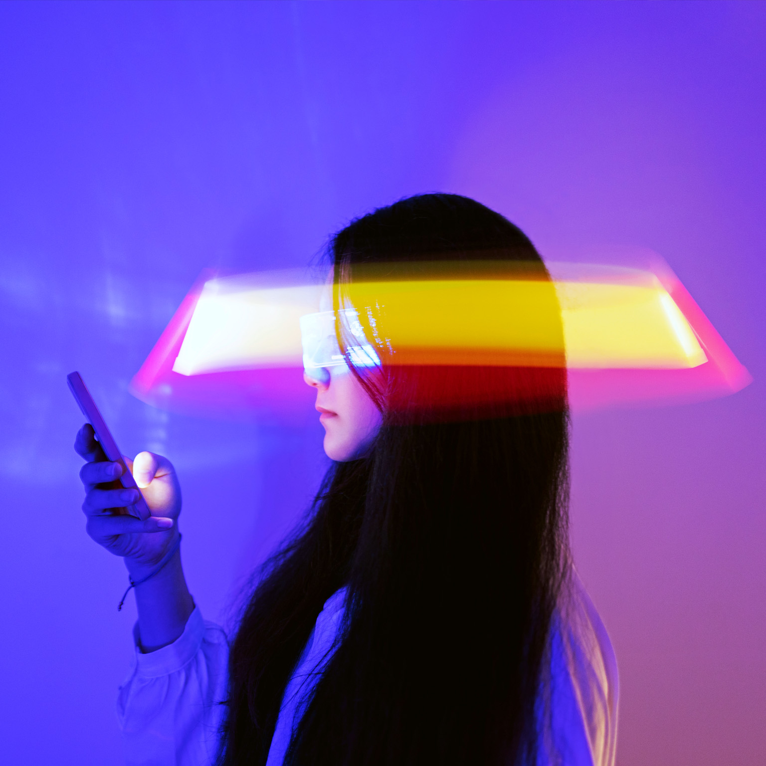 Asian woman using smartphone surrounded by beams of light