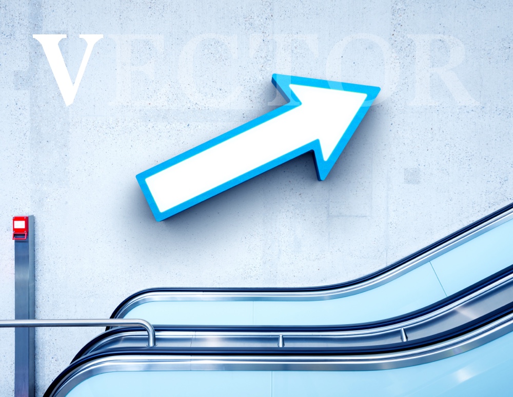 Large arrow on wall next to an escalator with the V highlighted in VECTOR text overlay