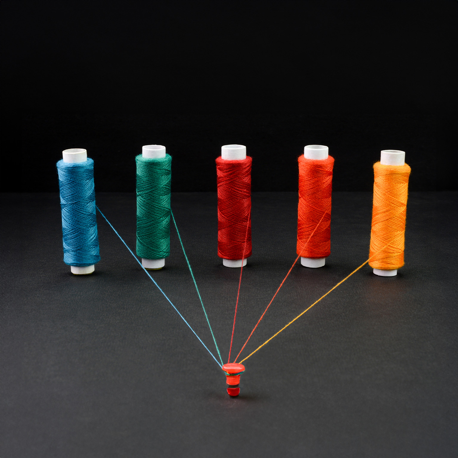 Multicolored spools of strings attached together, - stock photo