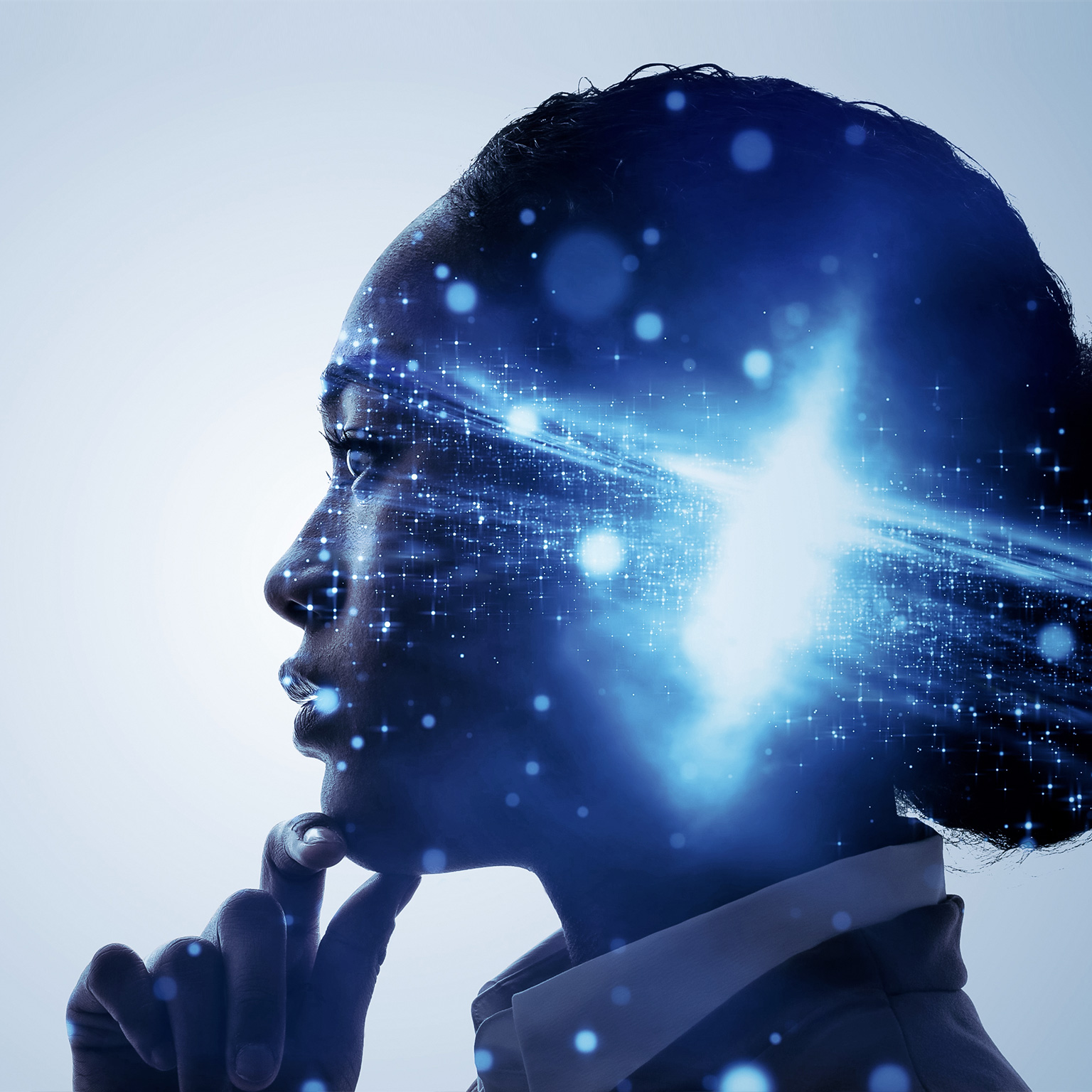 A profile of a woman with her hand up to her chin in a thoughtful pose. A galaxy bursting with light is superimposed over profile, centered over her mind.
