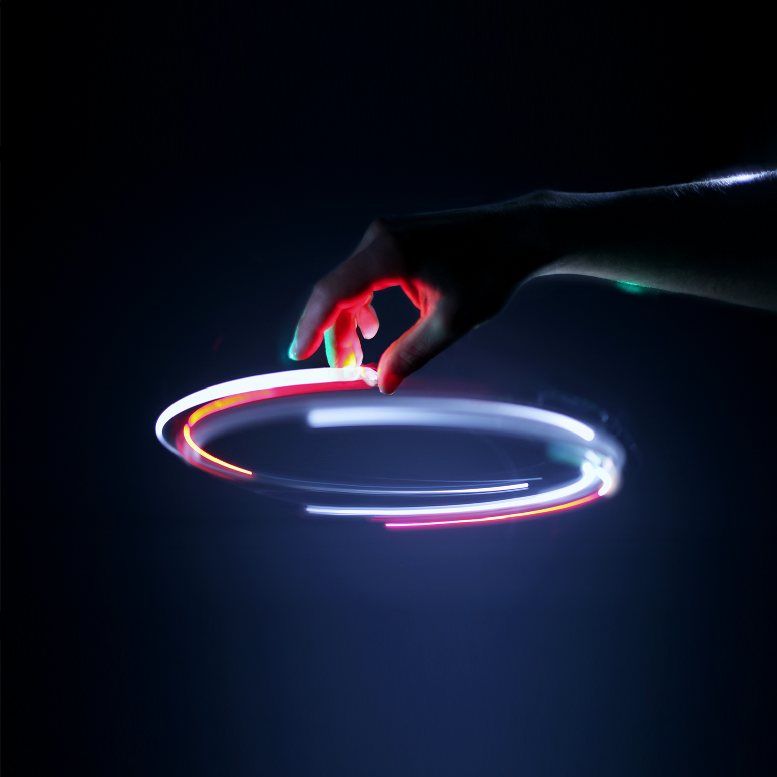Image of a hand tracing a light circle in the air