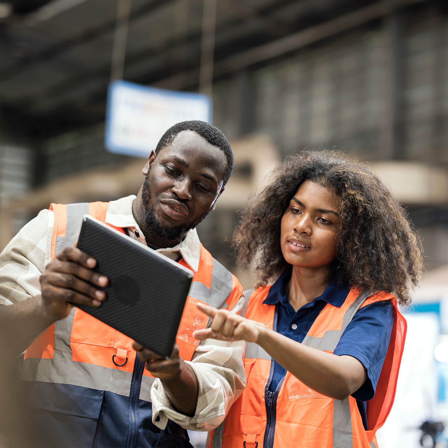 Production Control Engineers is having discussion on production daily report for resource planning related to production on tablet in factory shop floor. - stock photo