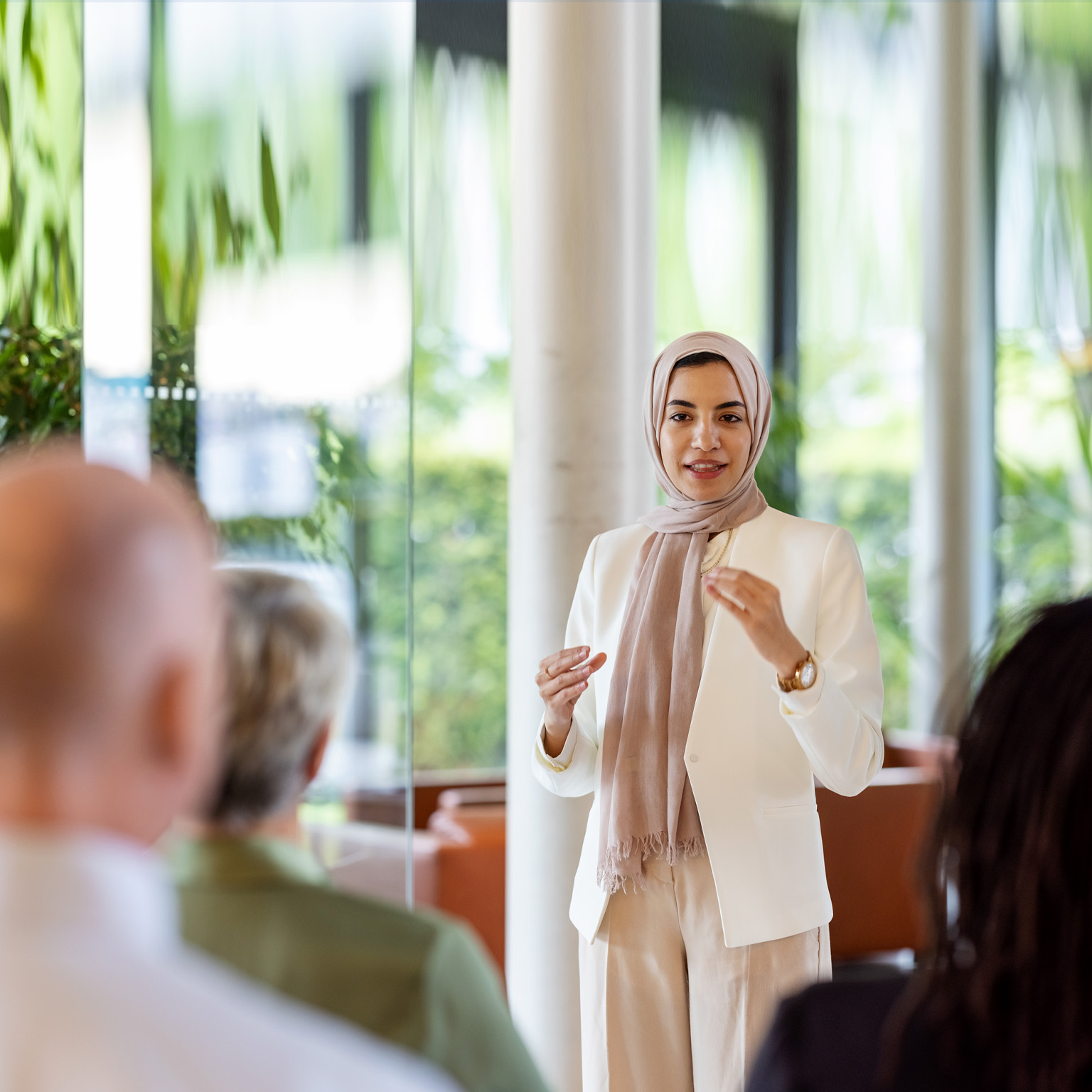 Muslim businesswoman addressing the audience in a conference - stock photo