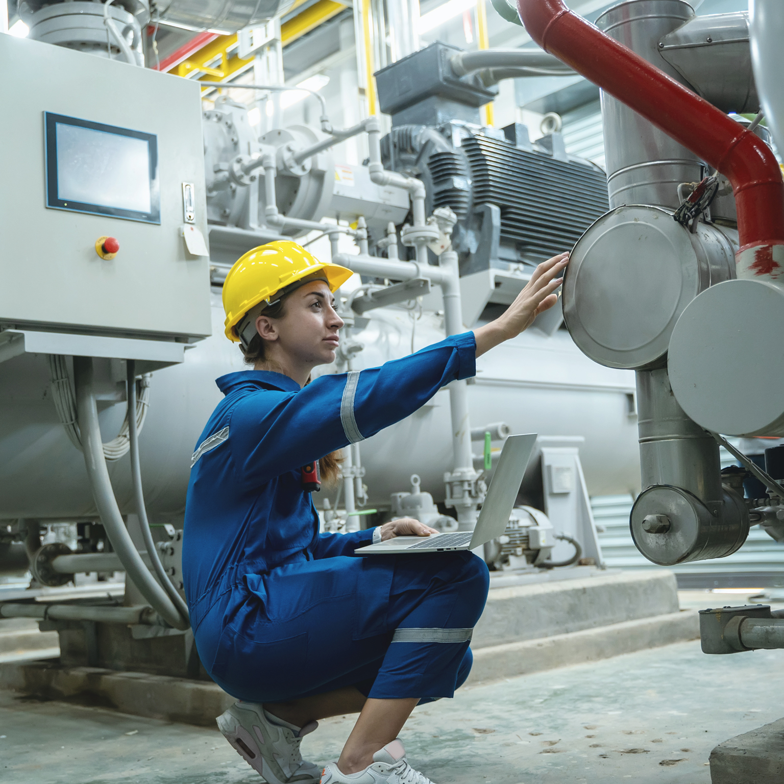 Electrical engineer woman working in an industrial boiler control room