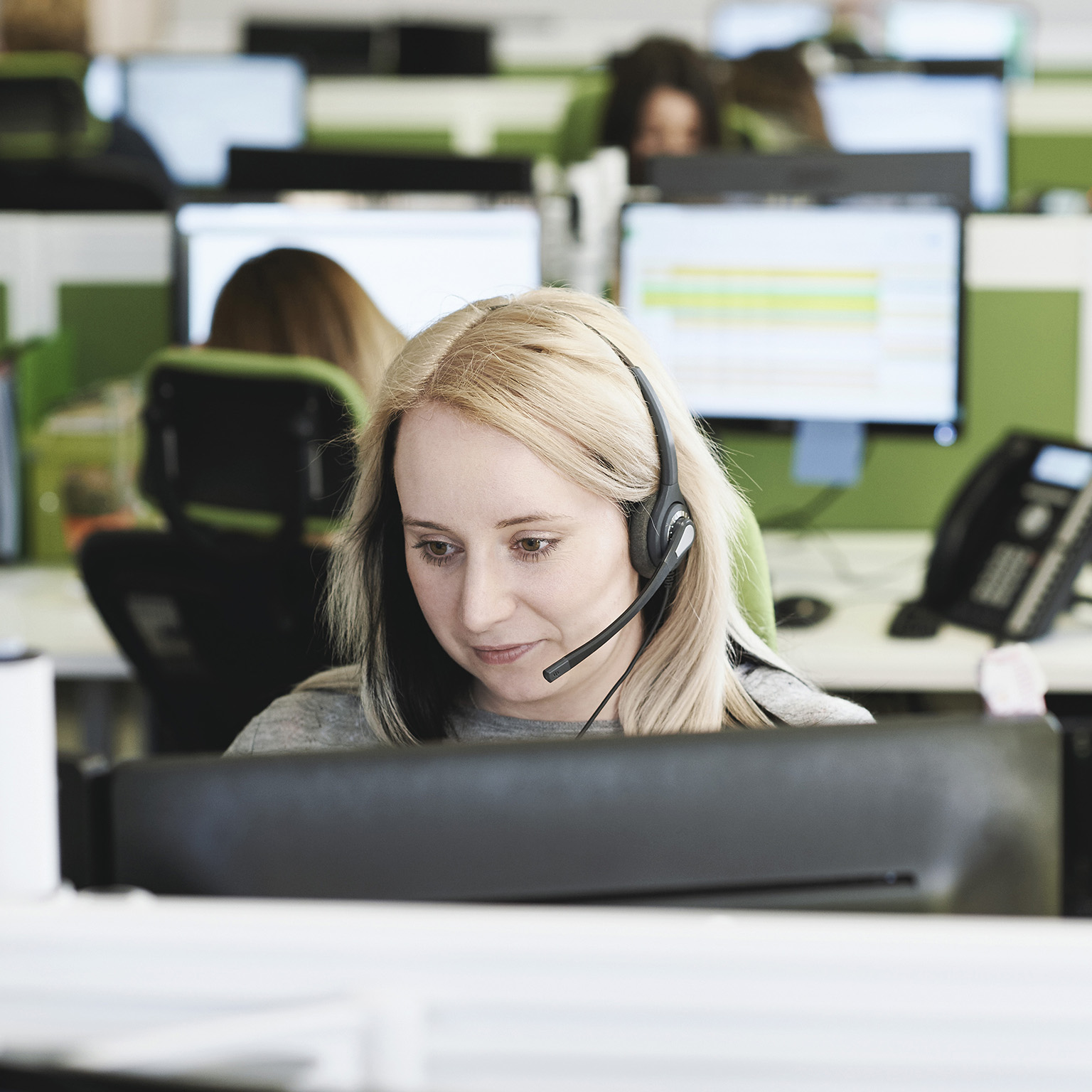 Young woman taking call in call center