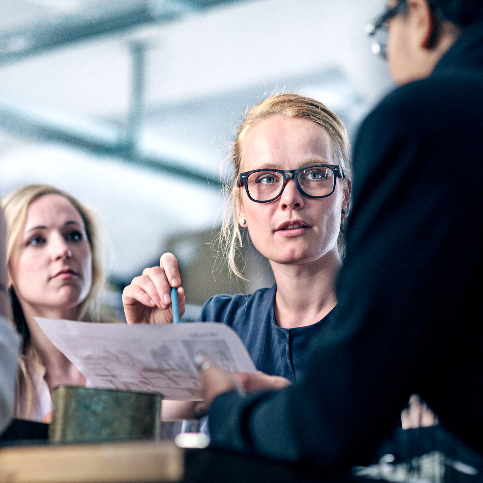 Women leading her team in business meeting