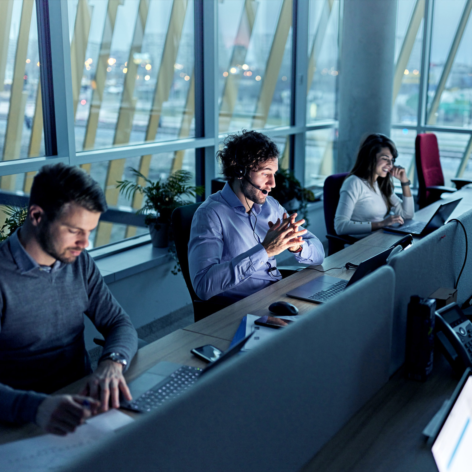 Business people working on laptops in a call center