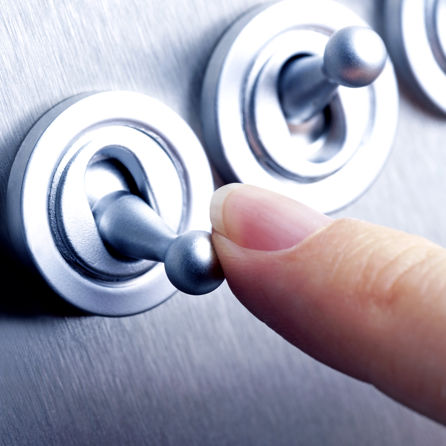Close-up image of a person flicking a switch.