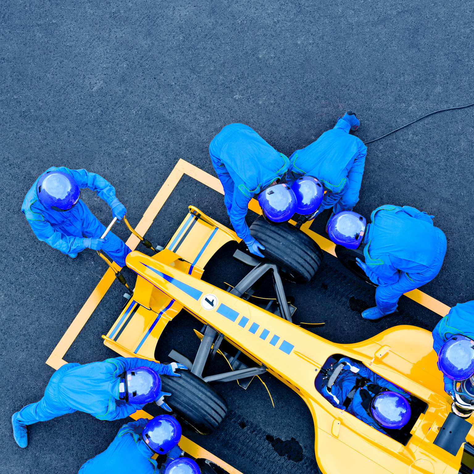 image of pit crew fixing a race car
