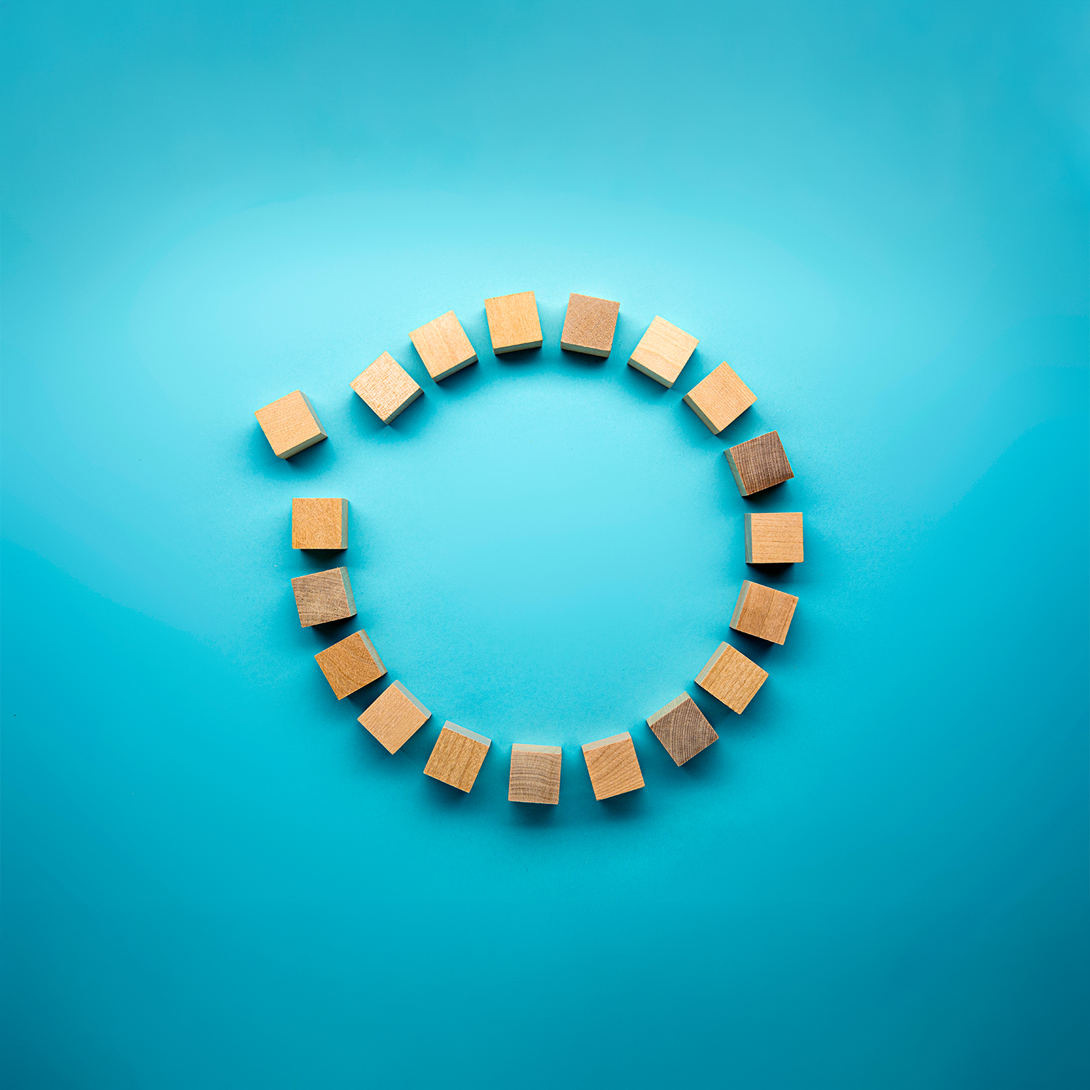 Wooden blocks in a circle on a blue background