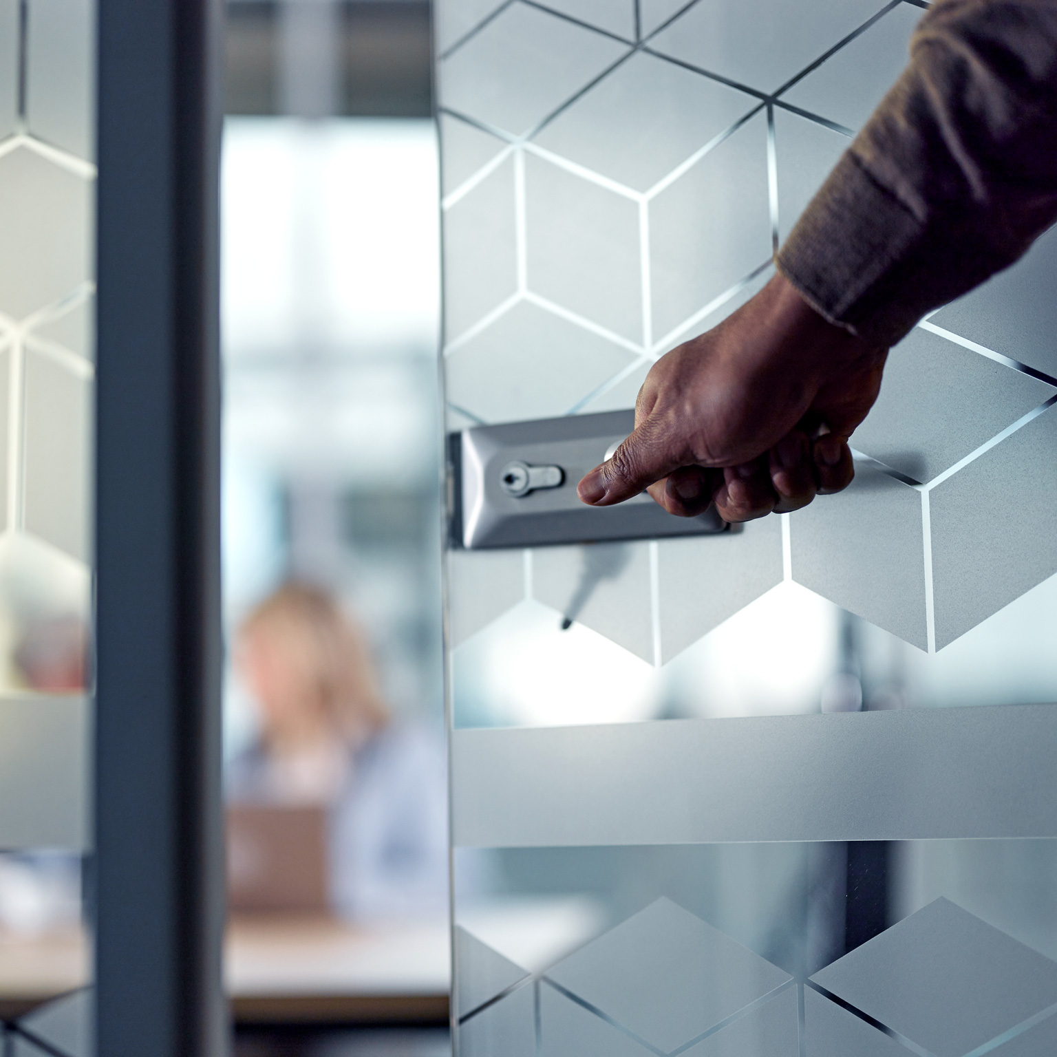 Close up of unrecognizable businessman opening an office door while entering