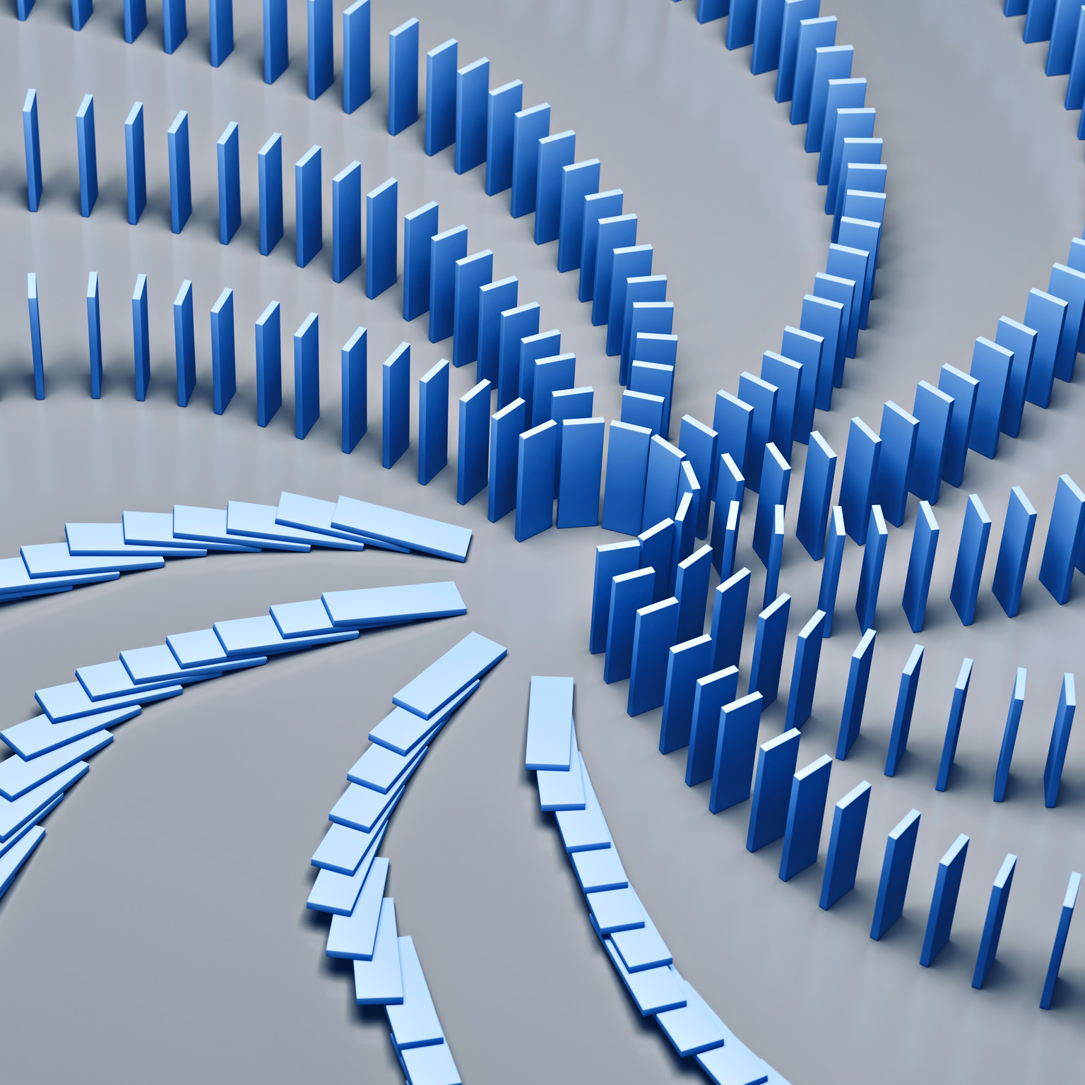 An array of dominoes cascading in a chain reaction on a blue backdrop