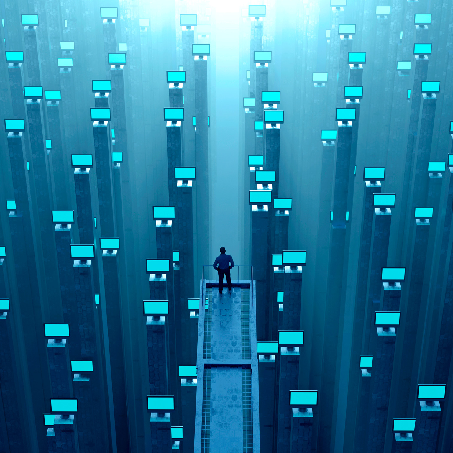 Man watching abundance of glowing computer monitors