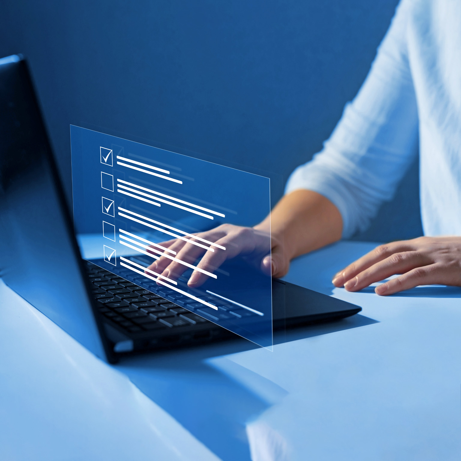Close up of a woman's hands on a laptop keyboard. A representation of a screen display floats over her hands showing boxes getting checked off as she answers quiz questions.