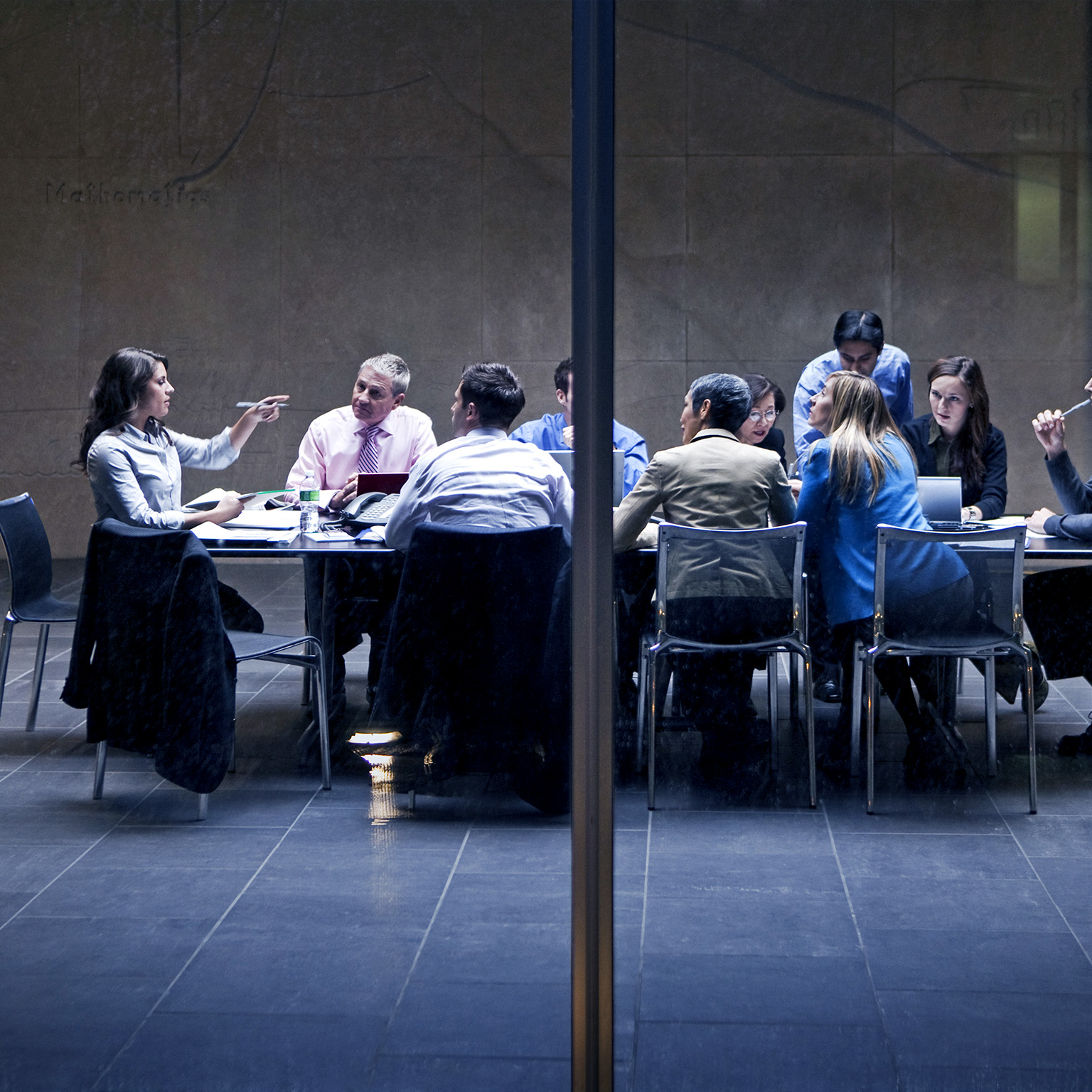 Image of a group of business professionals having a meeting in a modern office space.