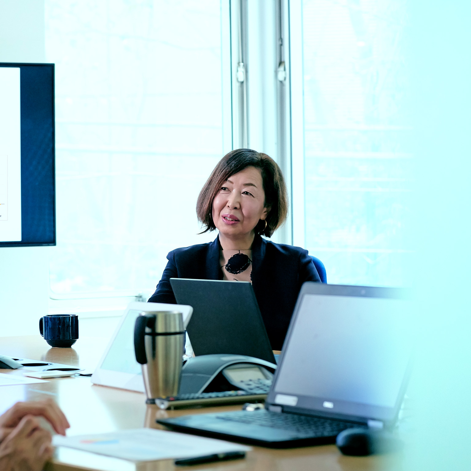 Female business owner talking during meeting in office conference room.
