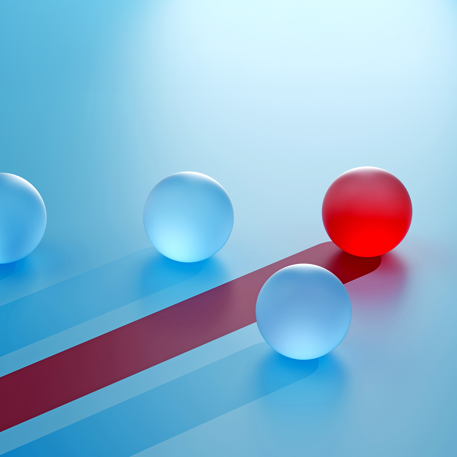 A single red sphere breaks away from identical blue spheres, moving on a distinct path. It symbolizes competitive advantage—standing out through differentiation, focus, and strategic direction.