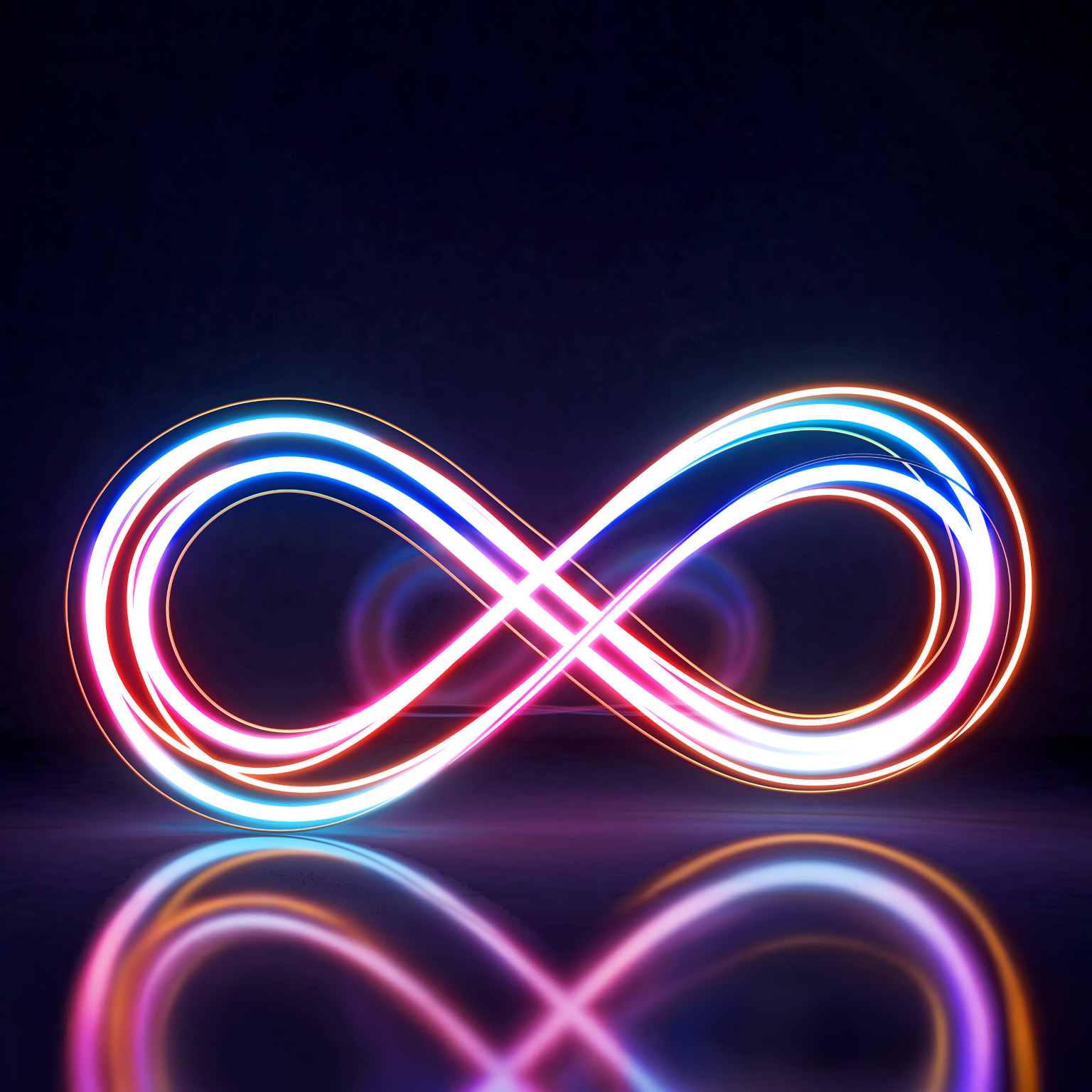 A glowing infinity symbol is formed by intertwined neon light trails in vibrant shades of pink, blue, and orange against a dark background.