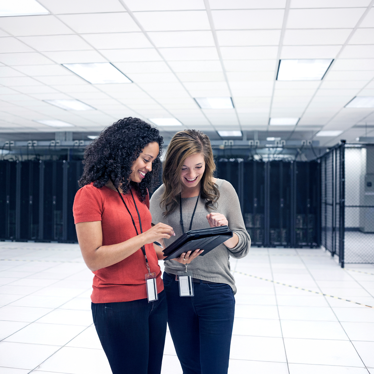 Businesswomen using tablet computer in server room