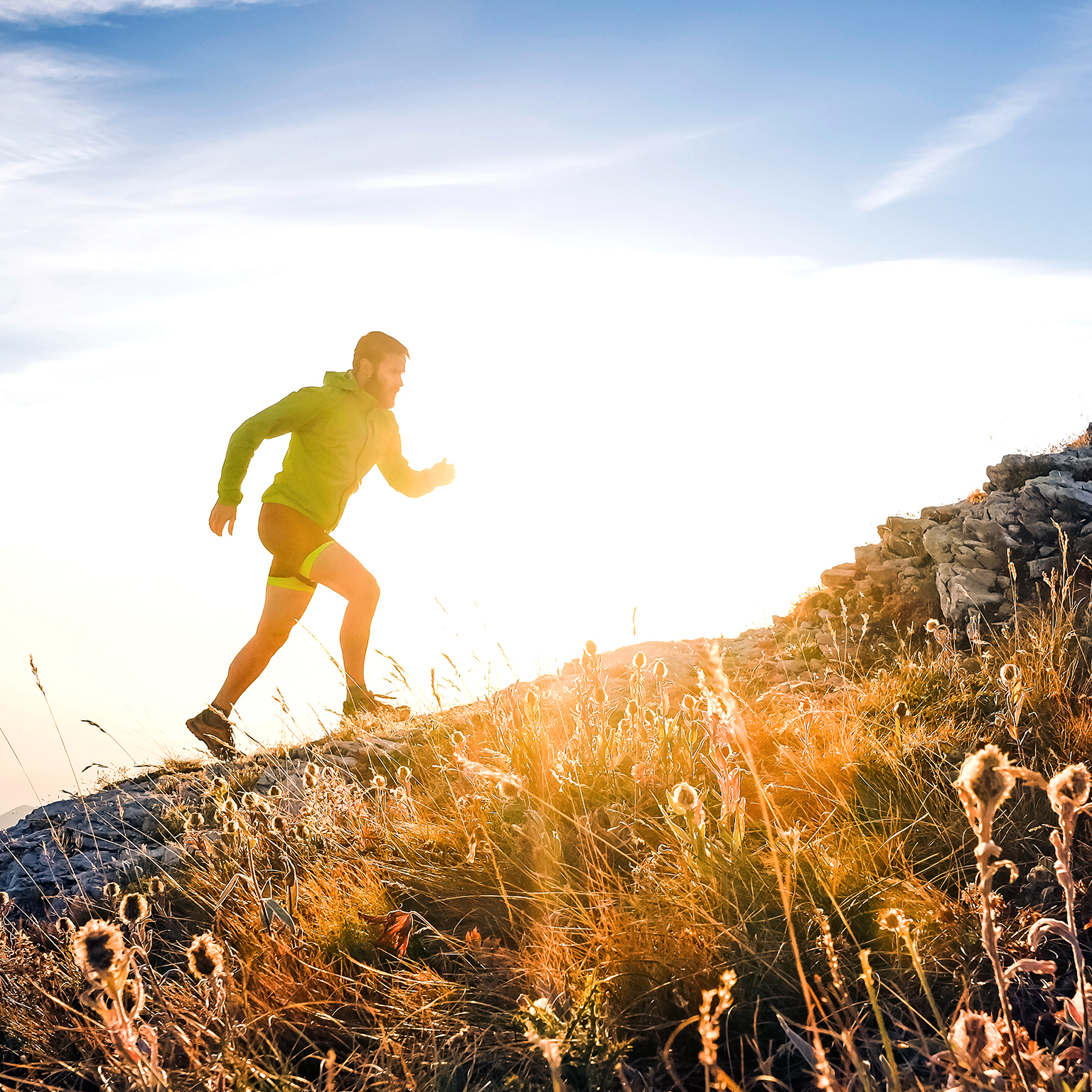 Italy, man running on mountain trail