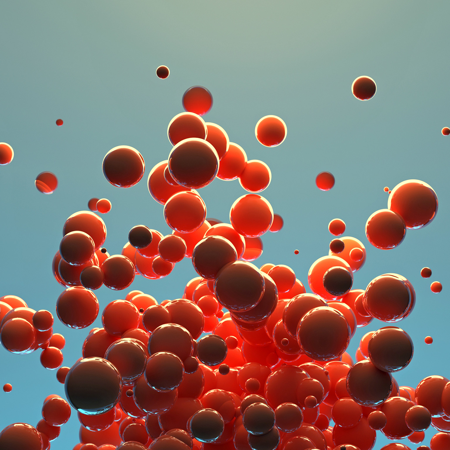 A cluster of red spheres of different sizes are released into the air