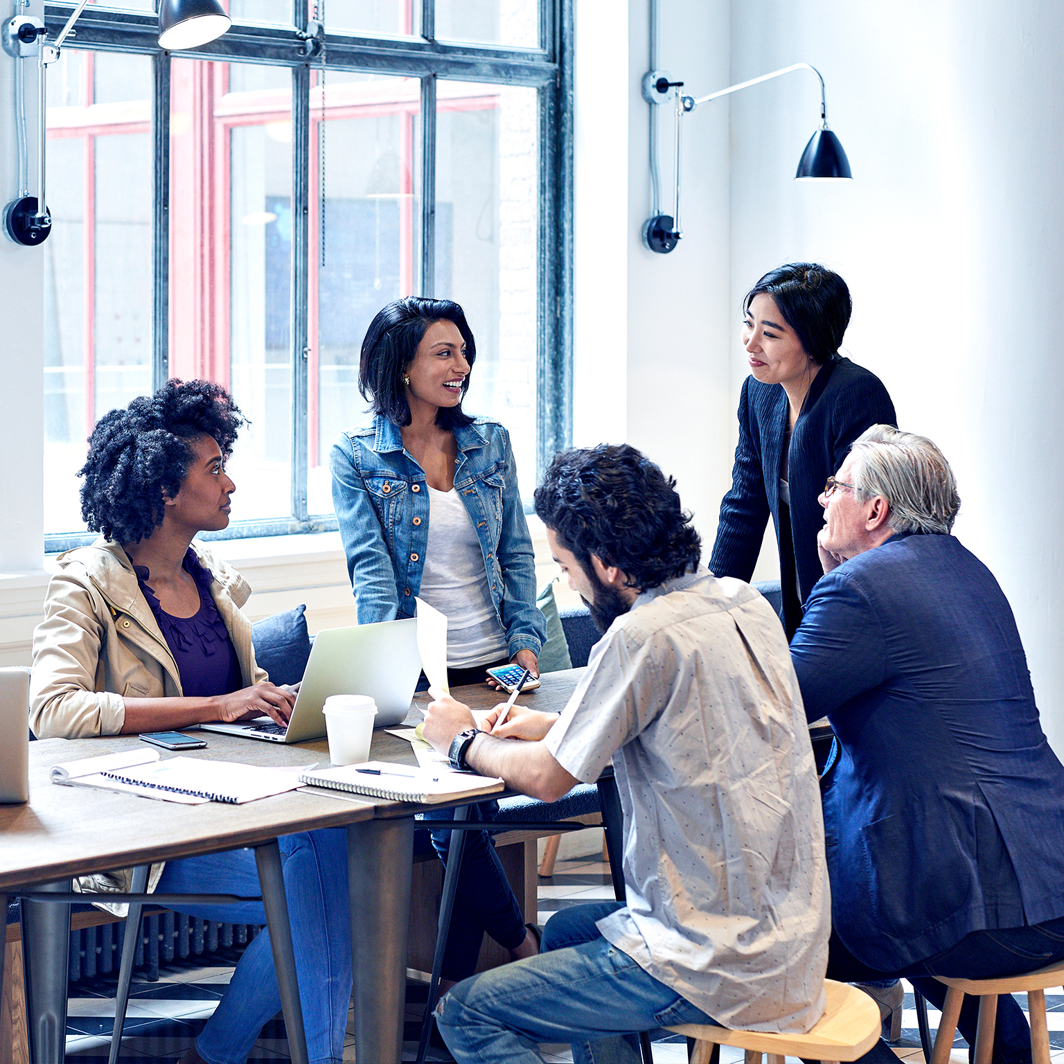 Diverse group of business people having discussion during meeting in office