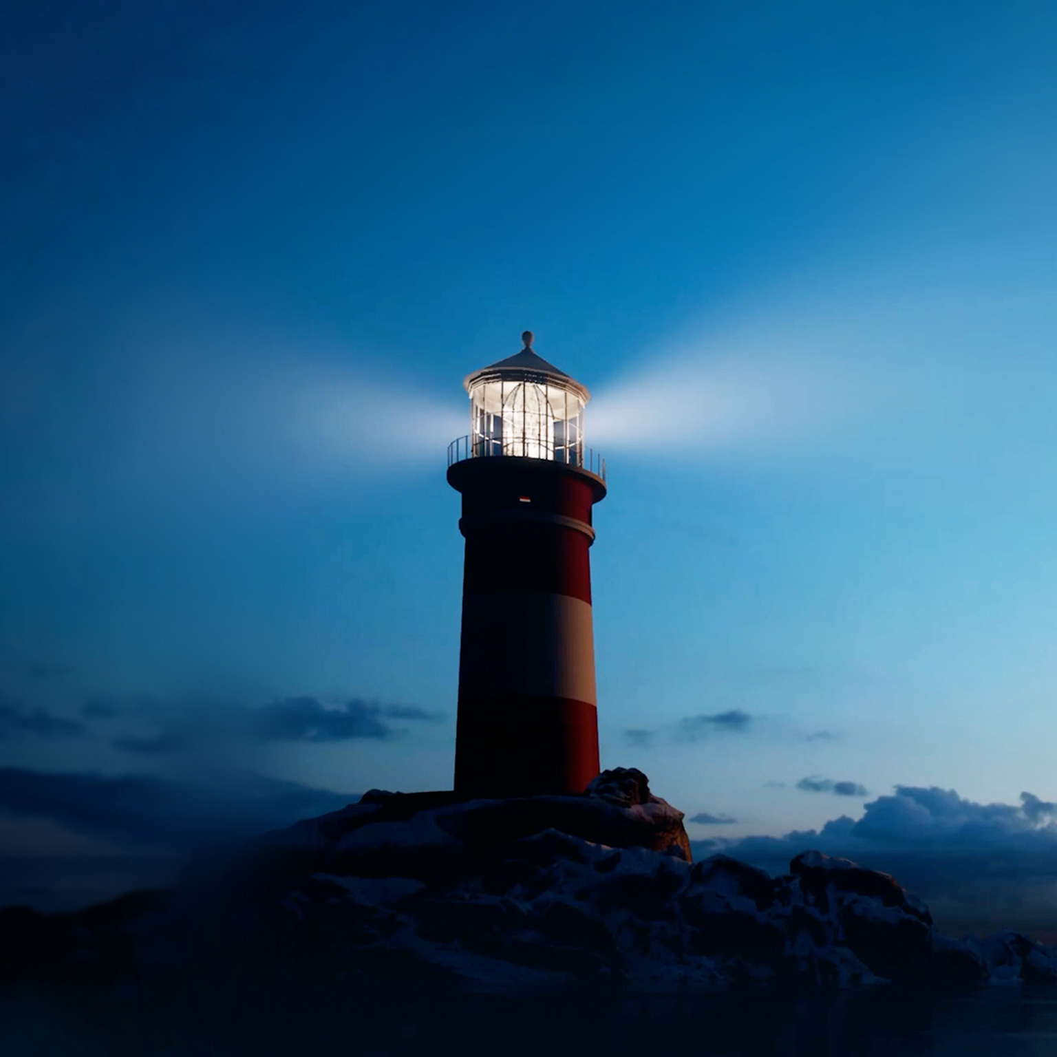 This image depicts a tall lighthouse with a prominent red and white striped pattern against a dark blue sky. The structure is situated on a dark, rocky foundation at the water's edge. The lighthouse is actively shining a bright, focused beam of light from its top lantern room.