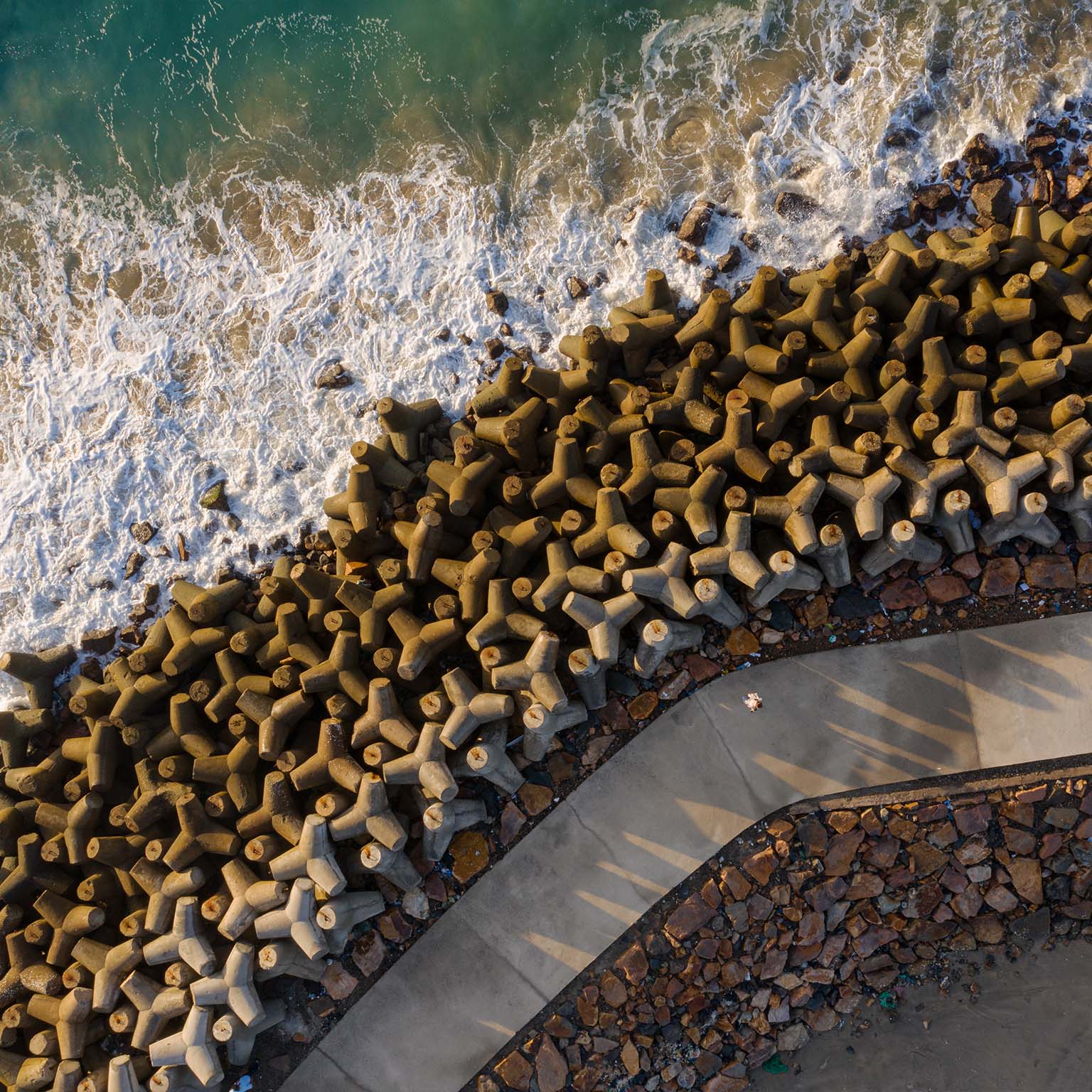 Drone view of breakwater in Phan Thiet beach in early morning, Binh Thuan province, central Vietnam