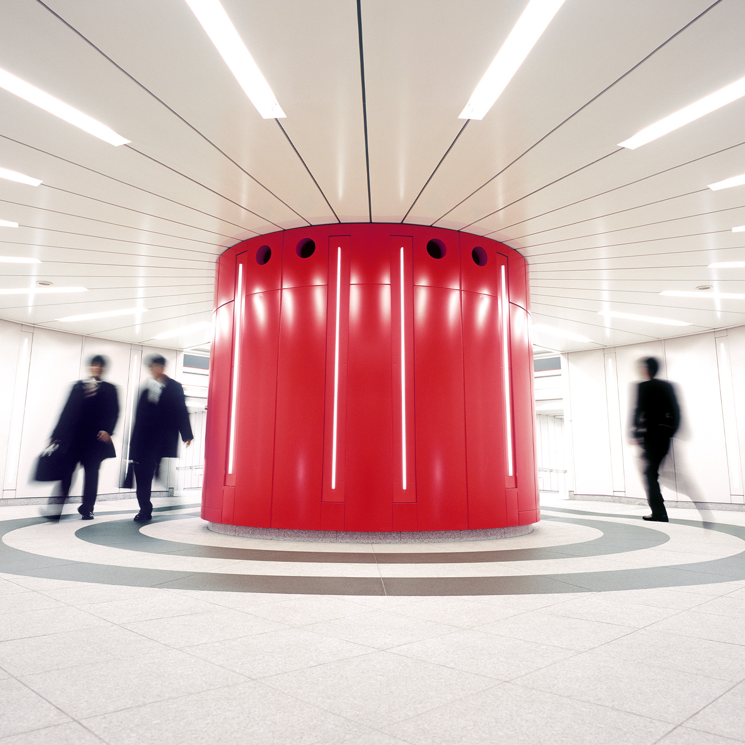 Businessmen crossing an underground underpass at a business district in Tokyo, Japan. - stock photo