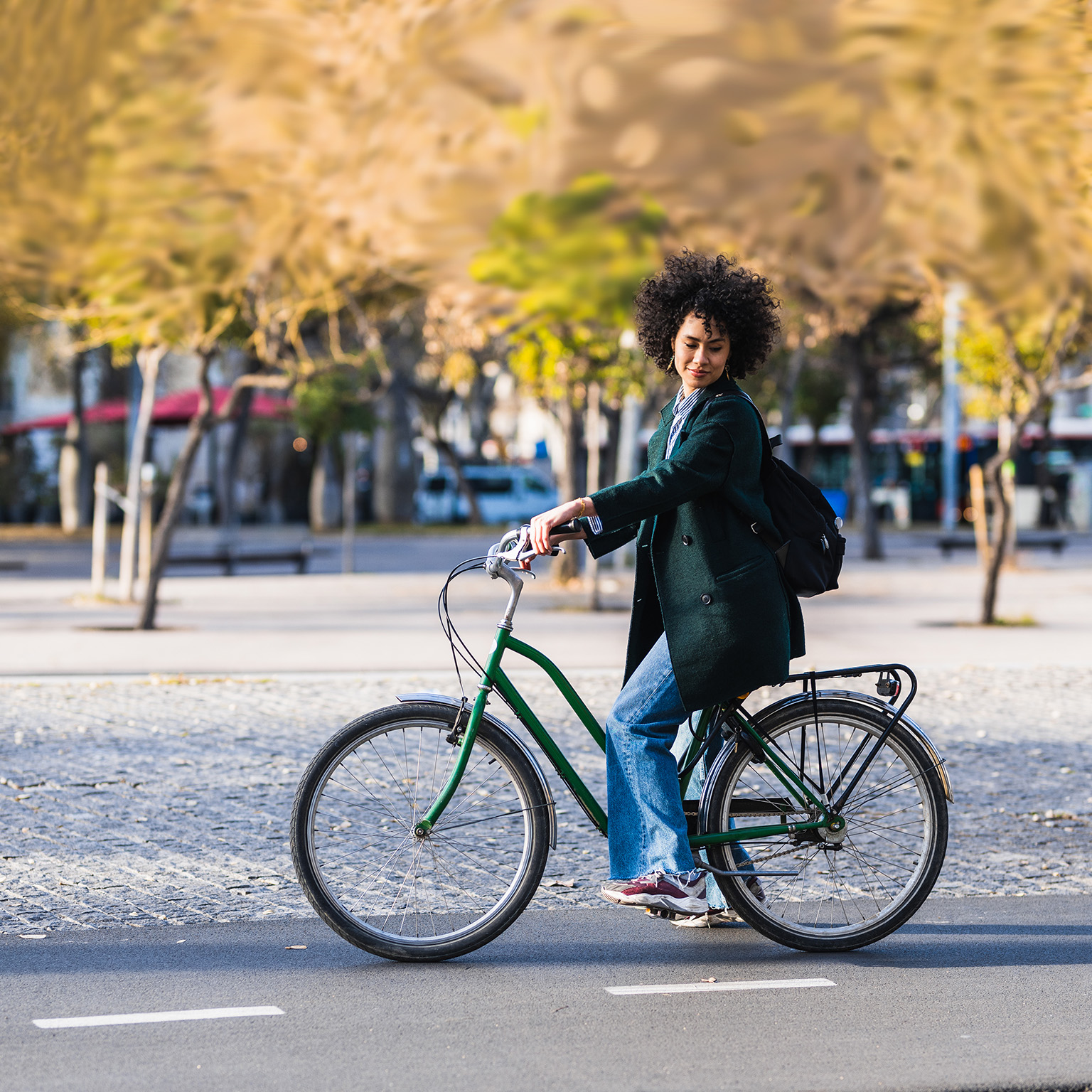 Woman riding commuter bicycle in hypothetical city. - photo