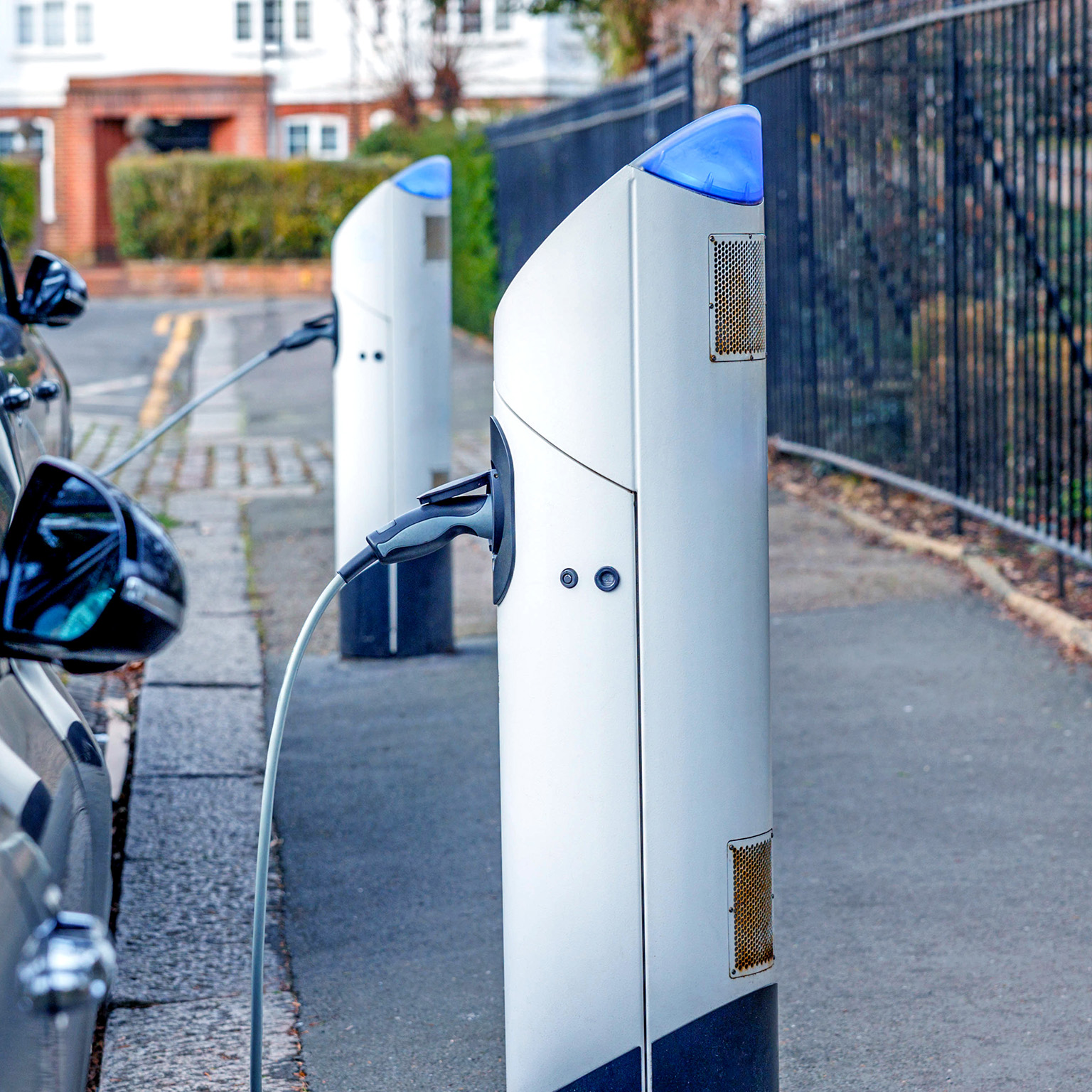 Electric cars standing in a row and charging at a public charger point