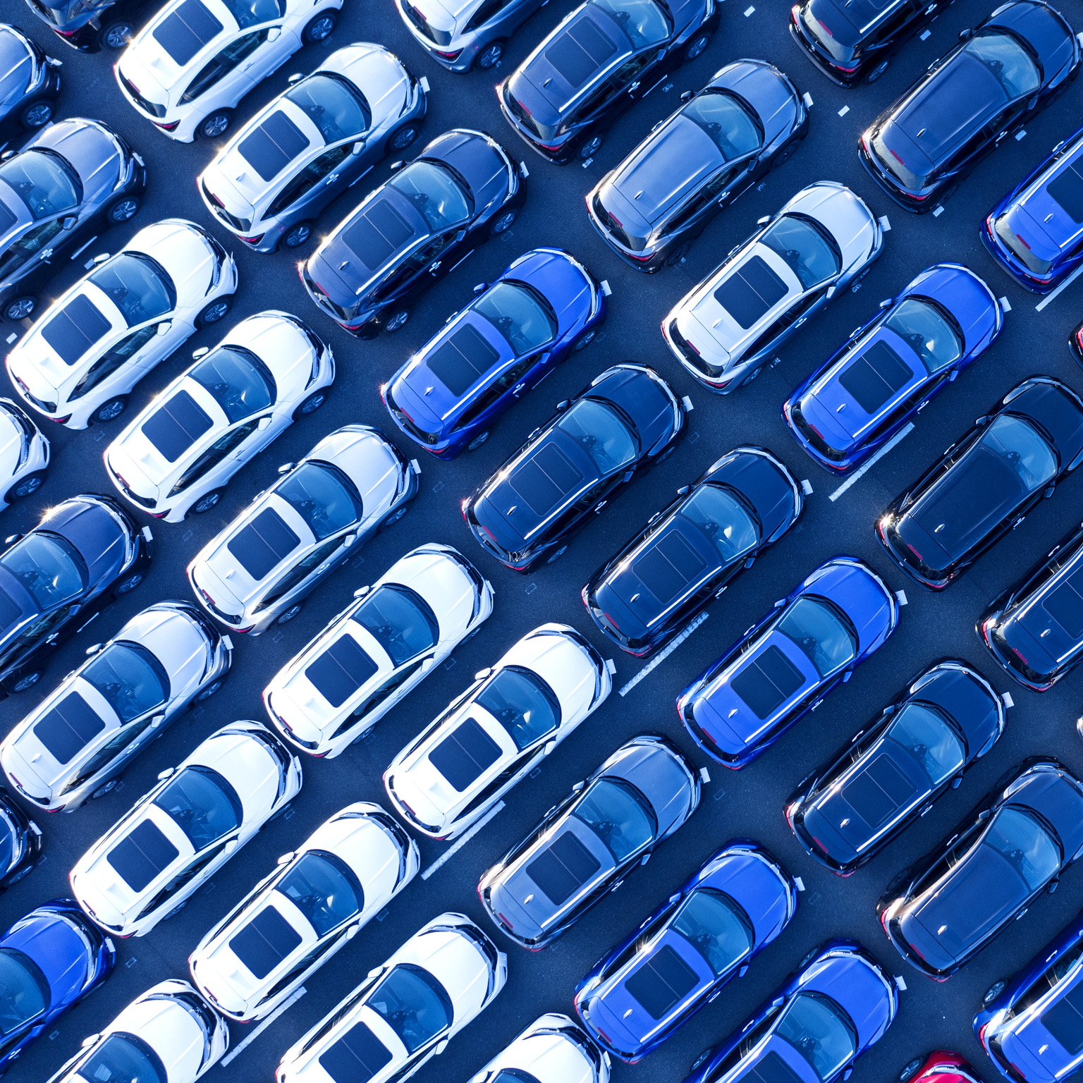 Aerial view of cars parked in many rows