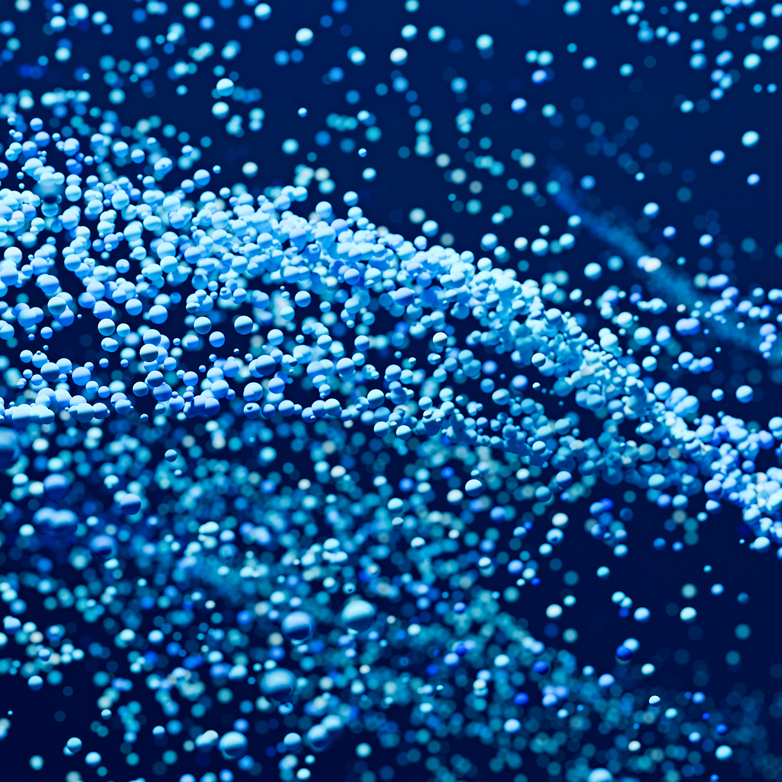 Abstract background with many blue and cyan spheres floating and flowing on a dark blue background, creating a sense of depth and motion