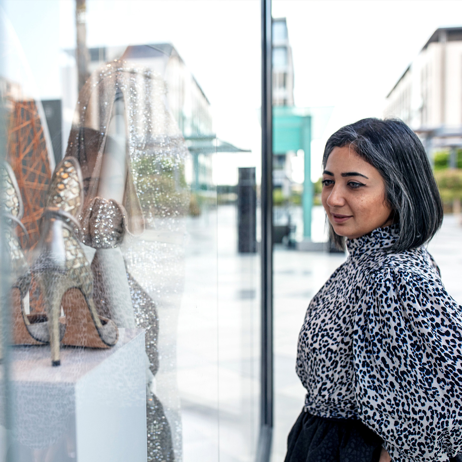 Middle Eastern woman window shopping