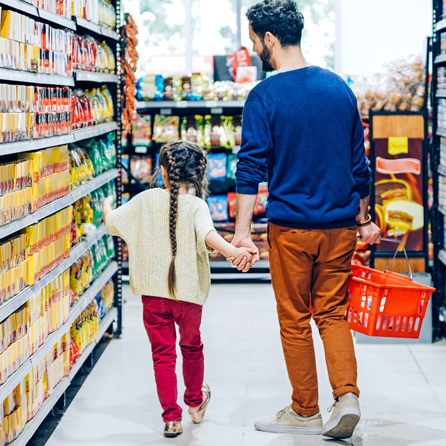 Man and child walking through department store aisles