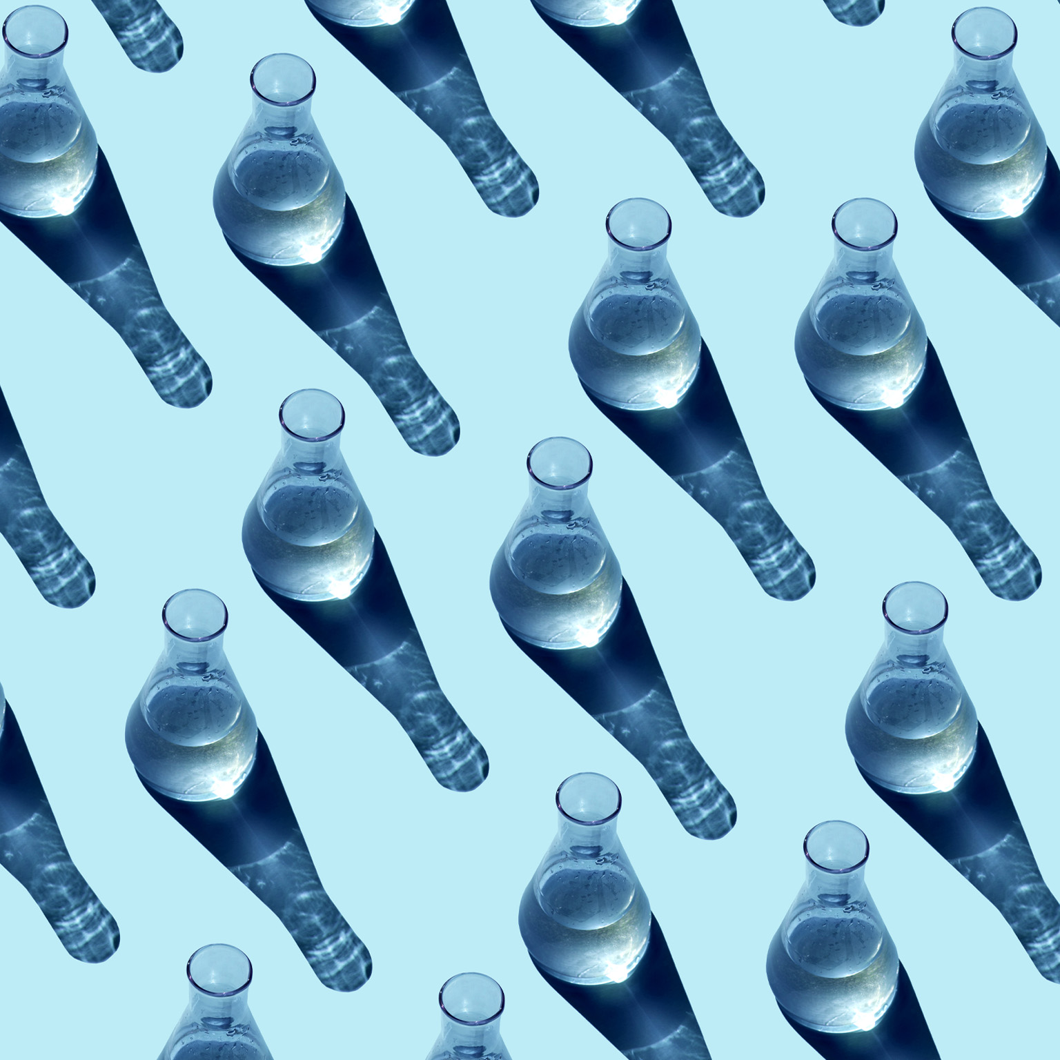 Seamless pattern made from glass beakers on a blue background.