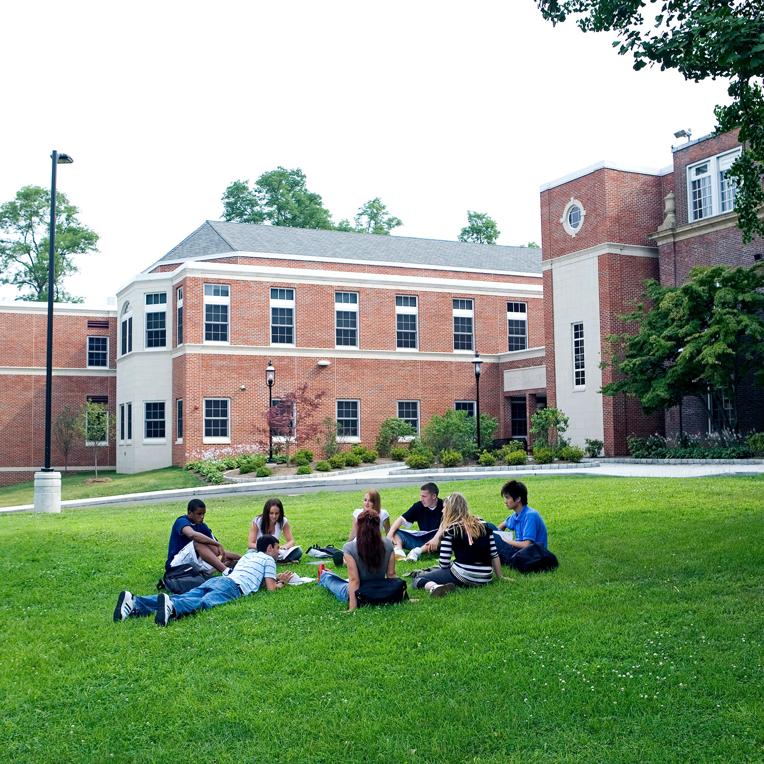 Group of friends (16-19) studying outdoors - stock photo