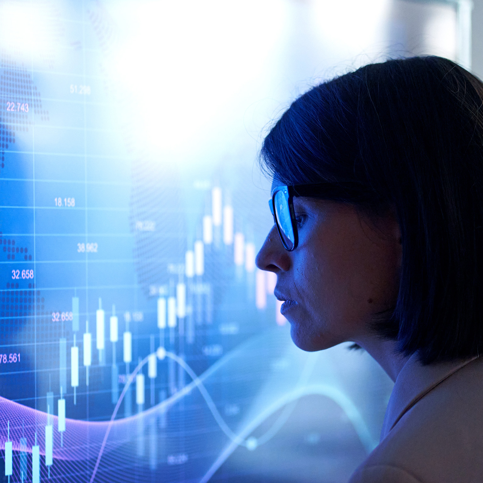 Profile of a business woman against the background of an investment chart