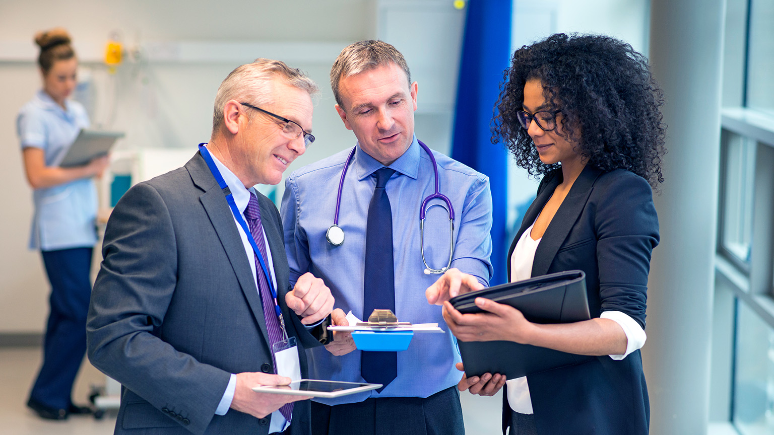 Three medical professional having a discussion in a medical room