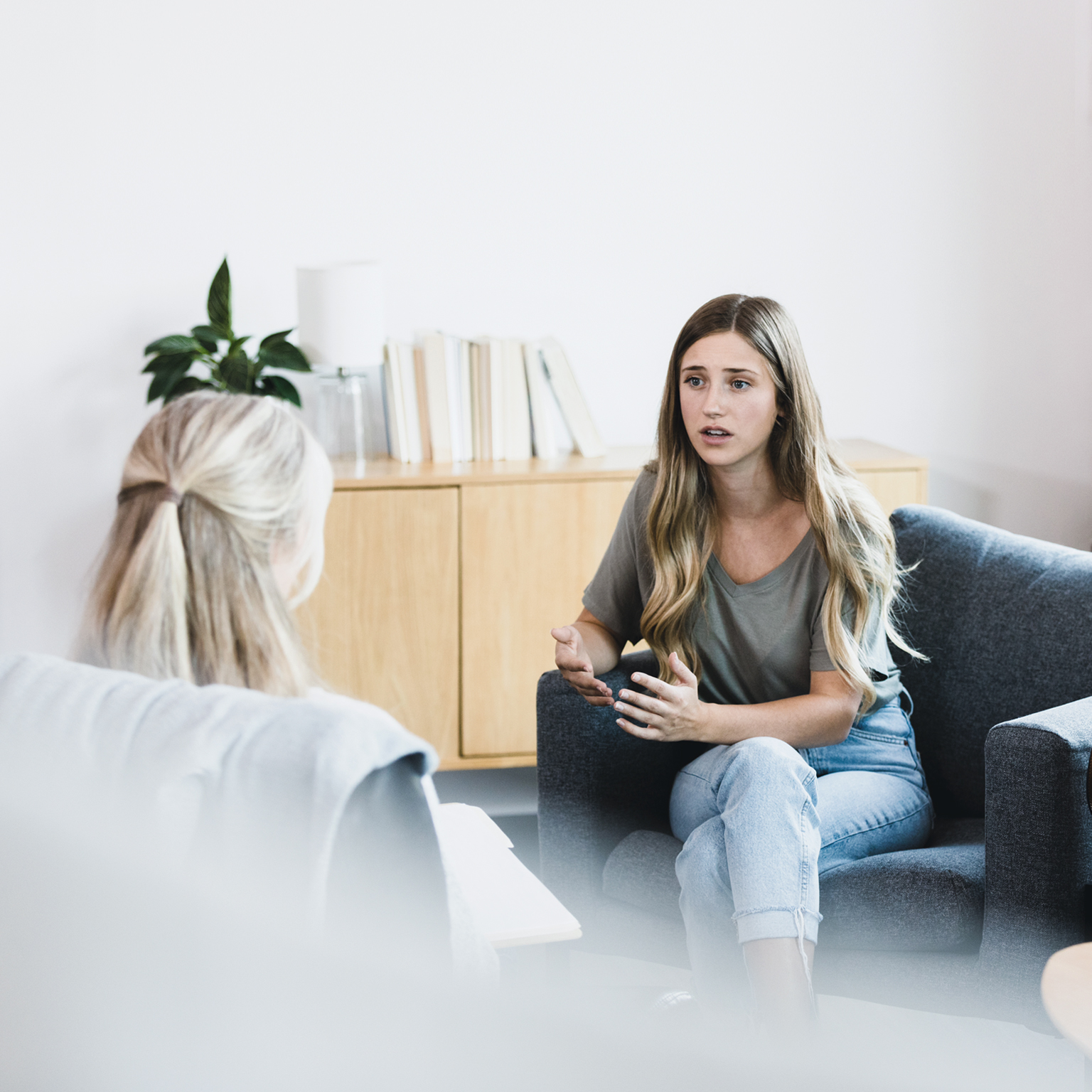 Young woman talks with therapist