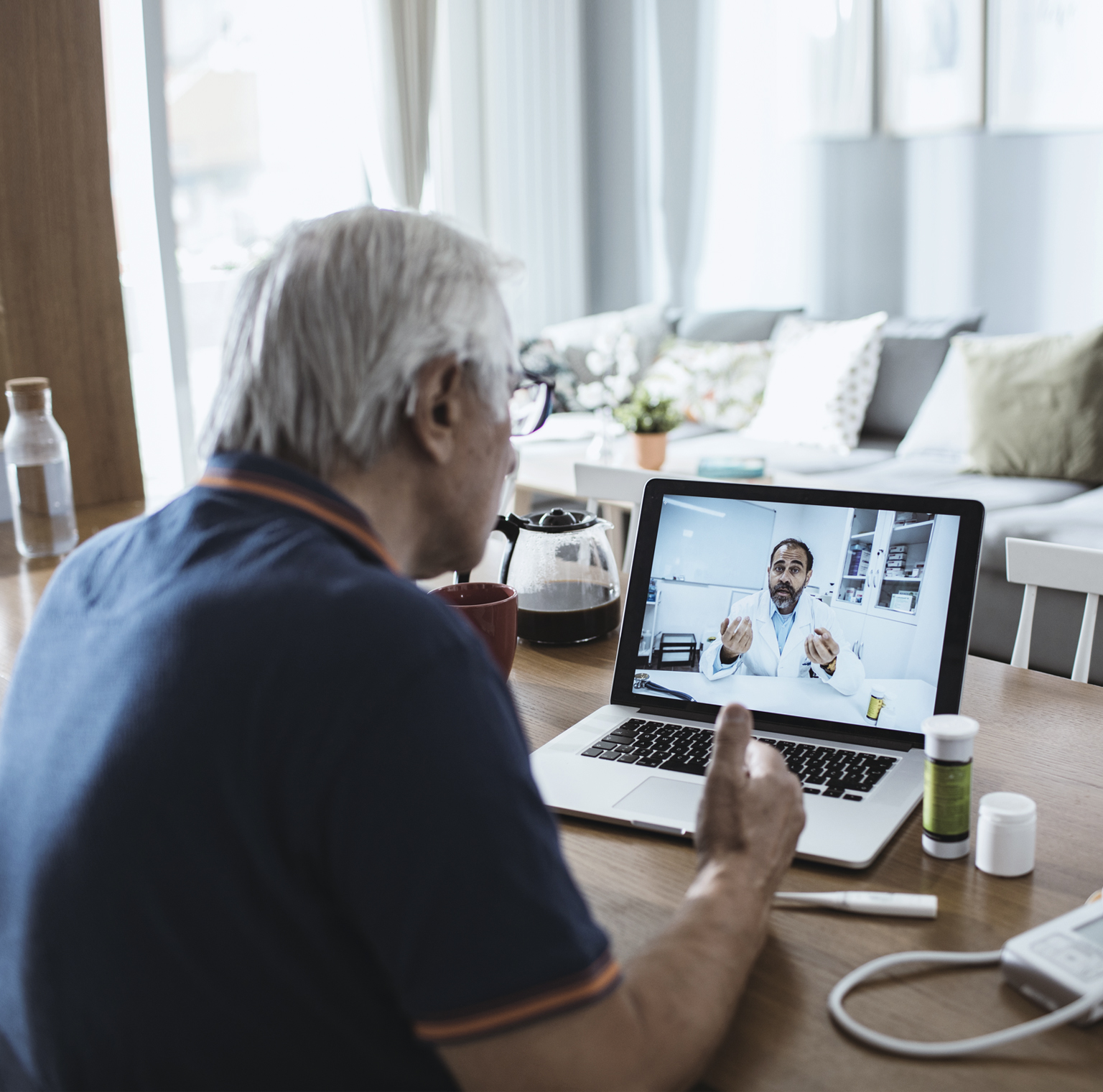 Senior man consulting with a doctor on his laptop.