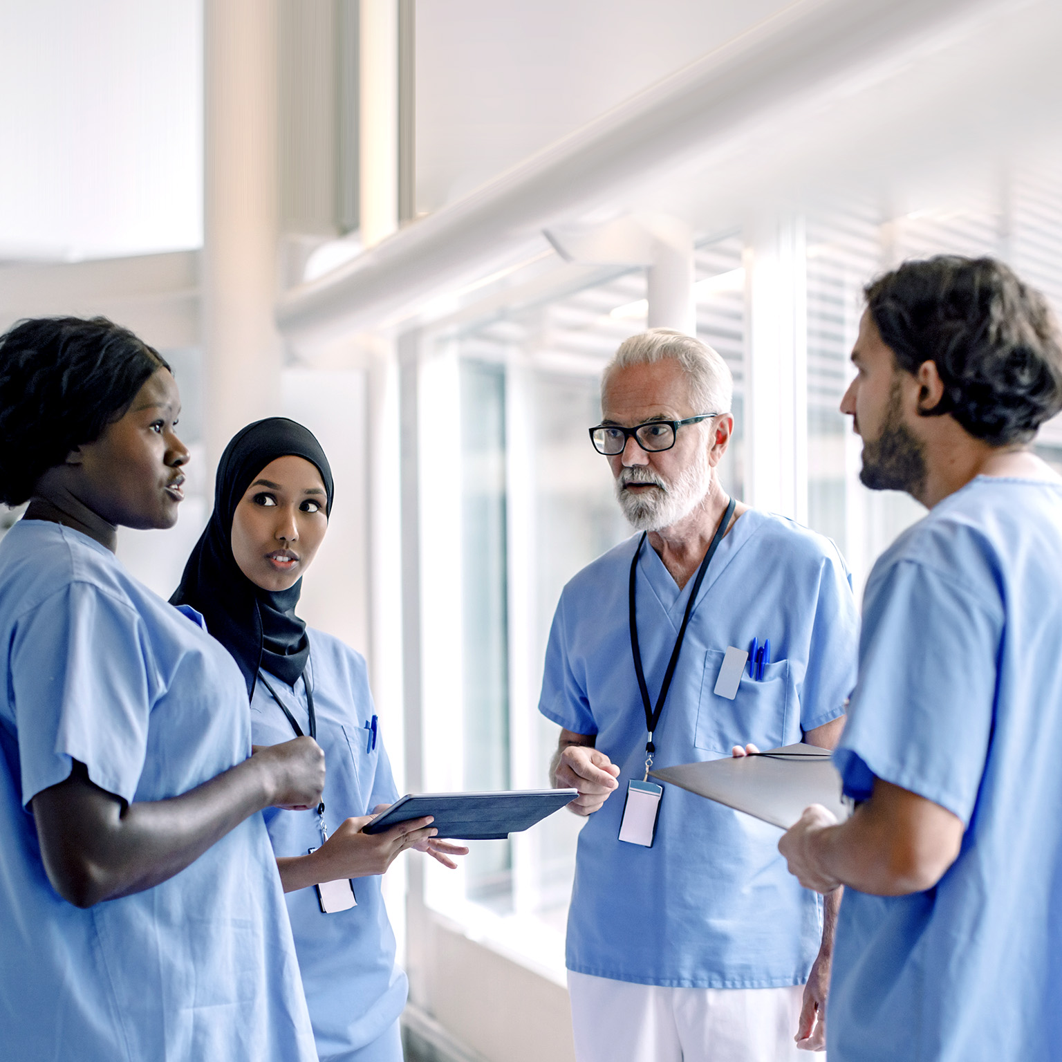 Image of a diverse group of nurses talking in a hospital.