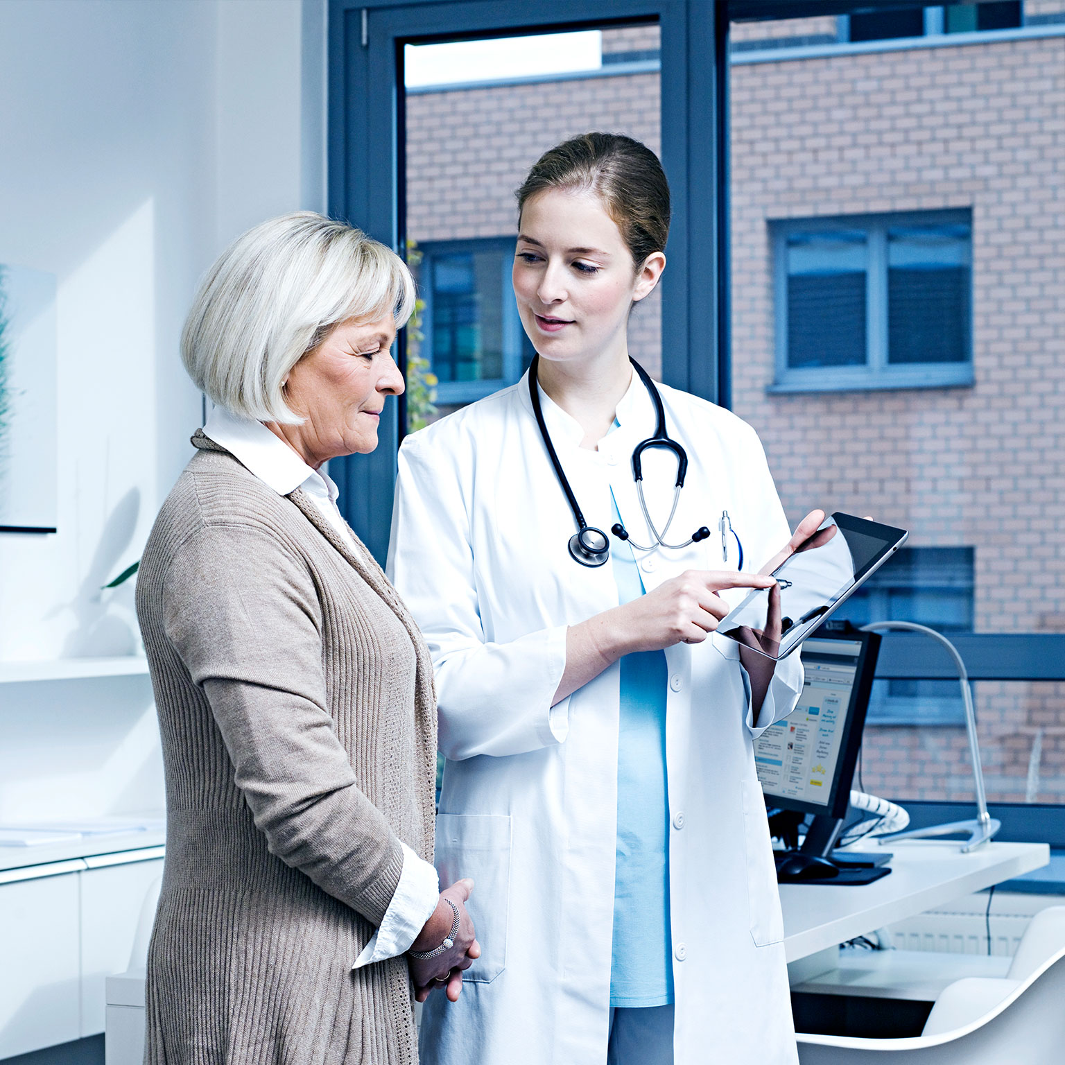 Doctor showing patient results on digital tablet