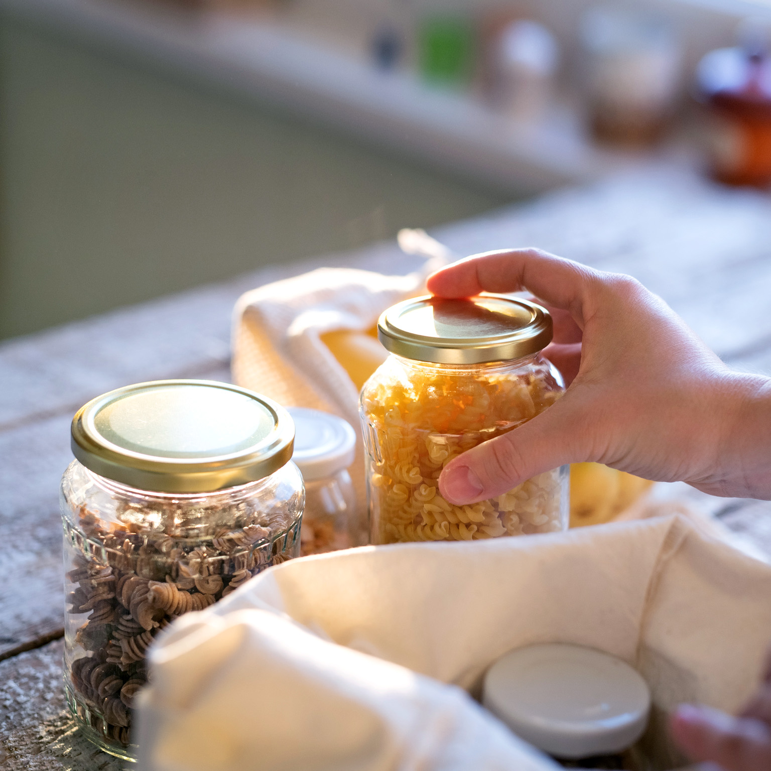 Woman standing indoors, unpacking zero waste shopping