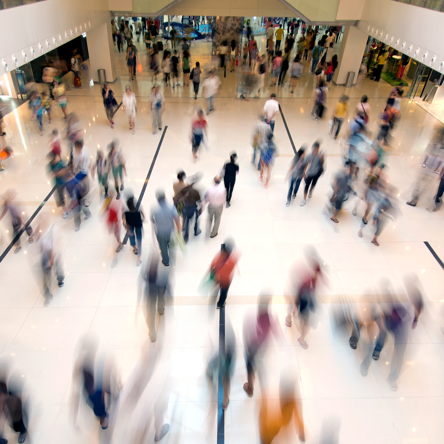 Crowd of people walking through a shopping mall