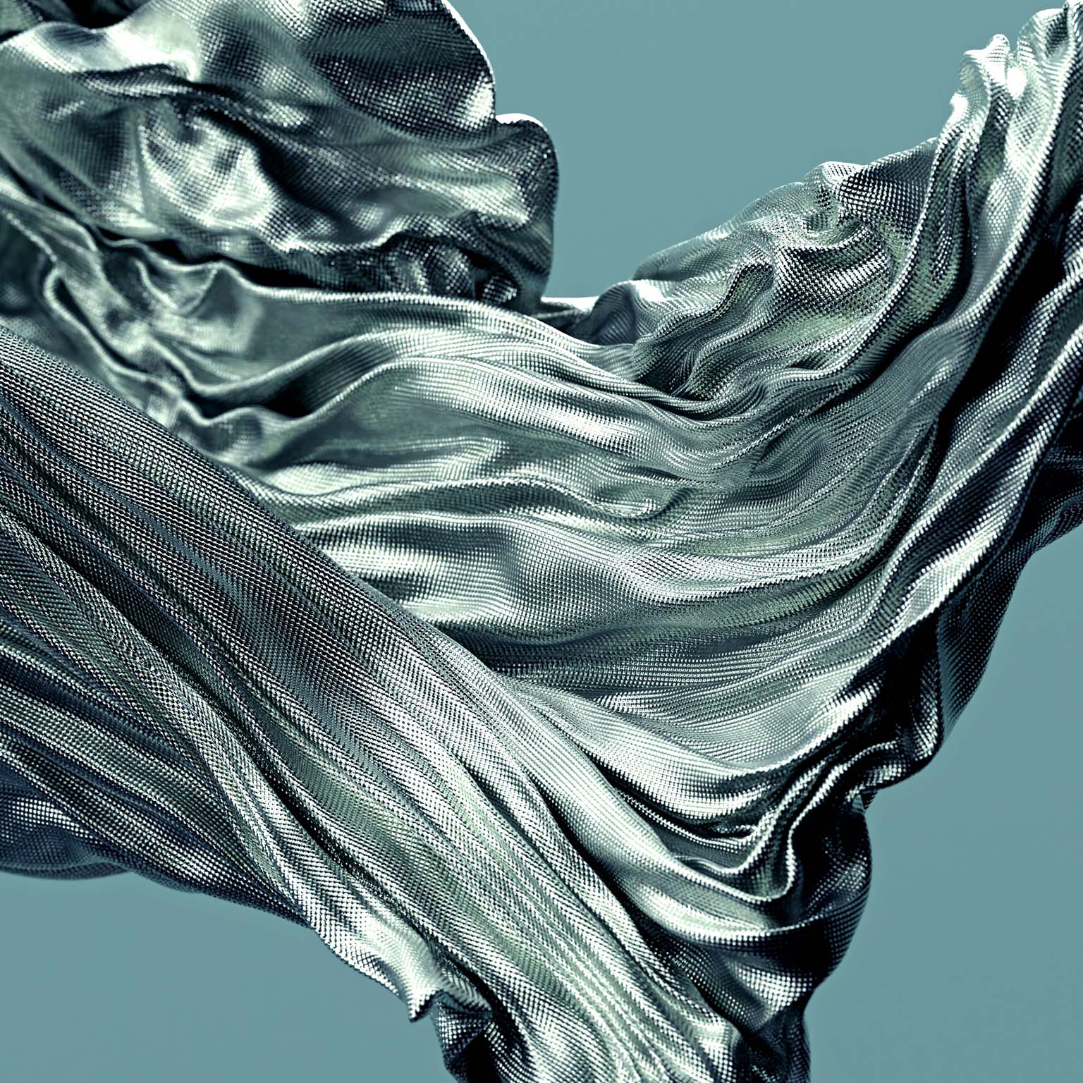 Fabric with a textured surface gracefully flowing and swirling in the air, creating dynamic folds and curves.